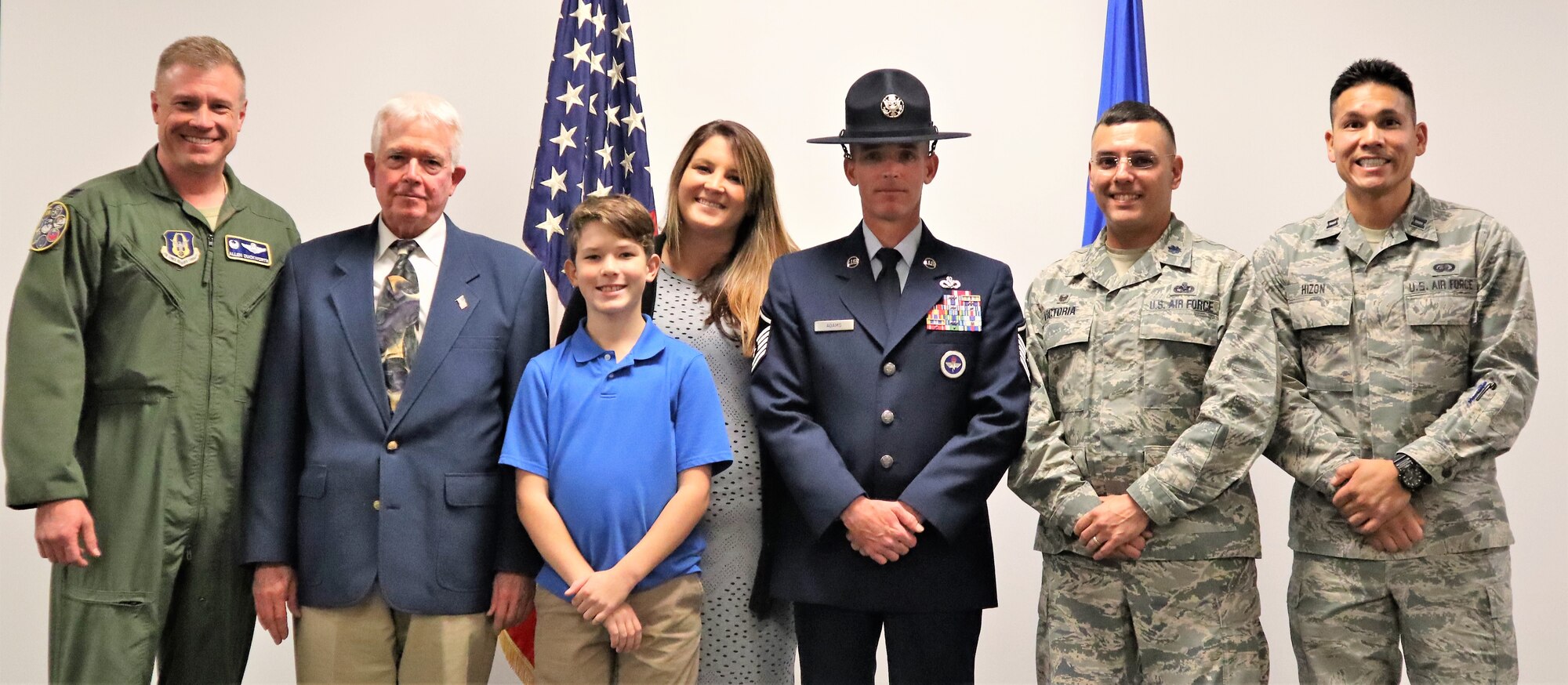 Col. Allen Duckworth, 340th Flying Training Group commander (Far left) stops for a photo with new MTI Master Sgt. Brian Adams, Lt. Col. Christopher Victoria-433rd Training Squadron (2nd-from right), Capt. Paul Hizon and Adams’ wife Jackie and son Tanner following graduation ceremonies held during the 22nd Air Force Senior Leader Summit Nov. 13-15 at Joint Base San Antonio-Lackland, Texas. (U.S. Air Force photo by Janis El Shabazz).