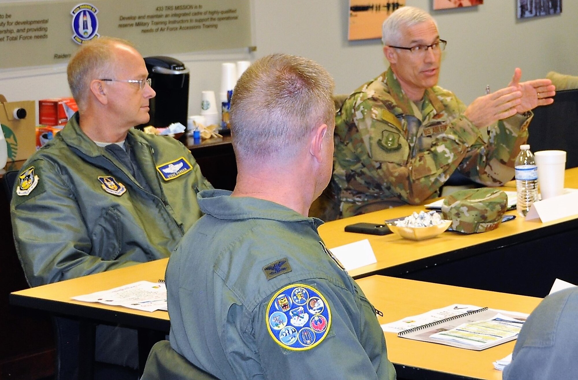 Maj. Gen. Craig LaFave, 22nd Air Force commander (far right), provides thanks  433rd Training Squadron Commander Lt. Col. Christopher Victoria for preparing a space for  the 22nd Air Force Senior Leader Summit held at Joint Base San Antonio-Lackland, Texas, Nov. 13-15. (U.S. Air Force photo by Janis El Shabazz).