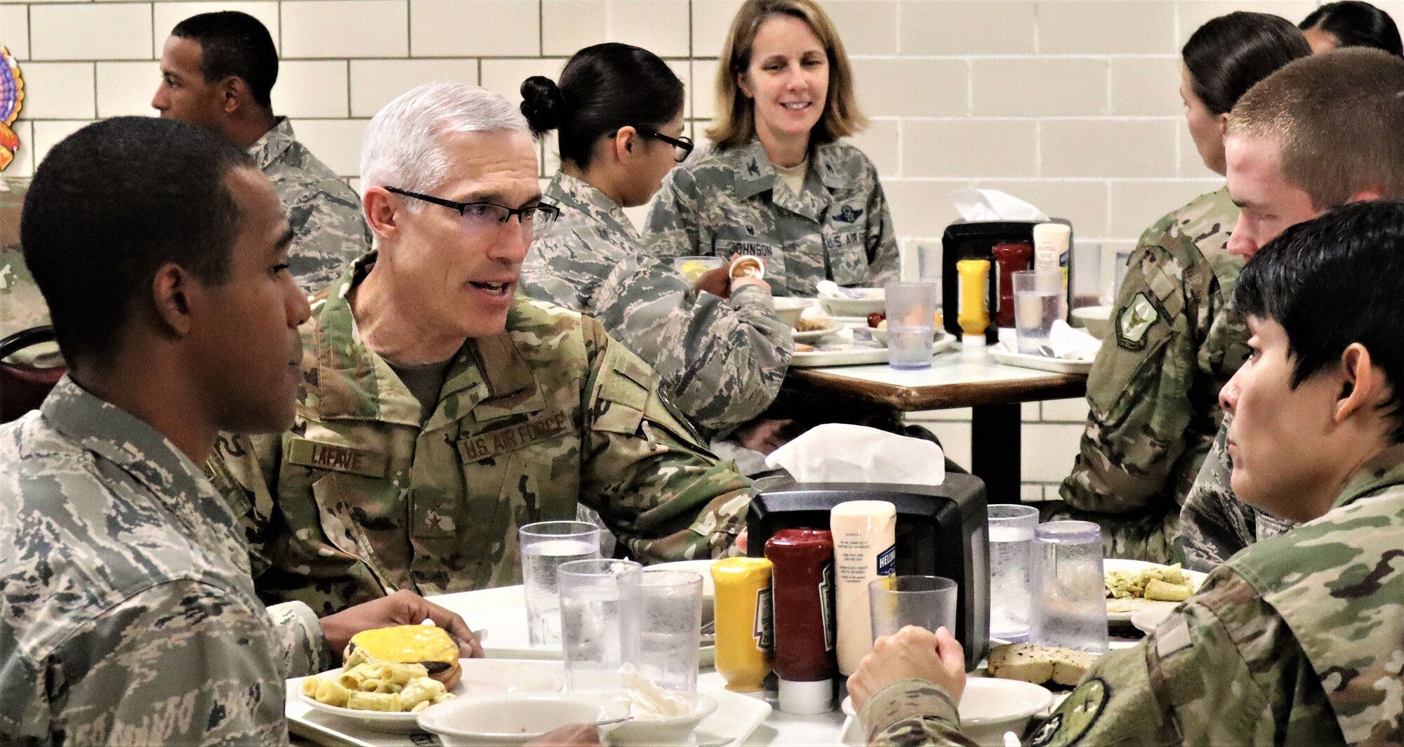Maj. Gen. Craig LaFave, 22nd Air Force commander and Chief Master Sgt. Imelda Johnson, 22nd AF Command Chief (far right), talk with basic trainees during the 22nd Air Force Senior Leader Summit Nov. 14 lunch with trainees at Joint Base San Antonio-Lackland, Texas. (U.S. Air Force photo by Janis El Shabazz).