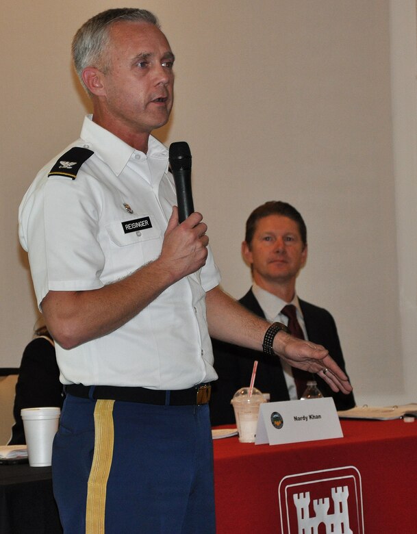 Col. Aaron Reisinger, commander of the U.S. Army Corps of Engineers Chicago District, left, speaks to community members during a public meeting about the Westminster/East Garden Grove Flood Risk Management Study, while David Van Dorpe, the Corps' Los Angeles District deputy District engineer and chief of the Program and Project Management Division, right, looks on Nov. 8 in Huntington Beach, California.