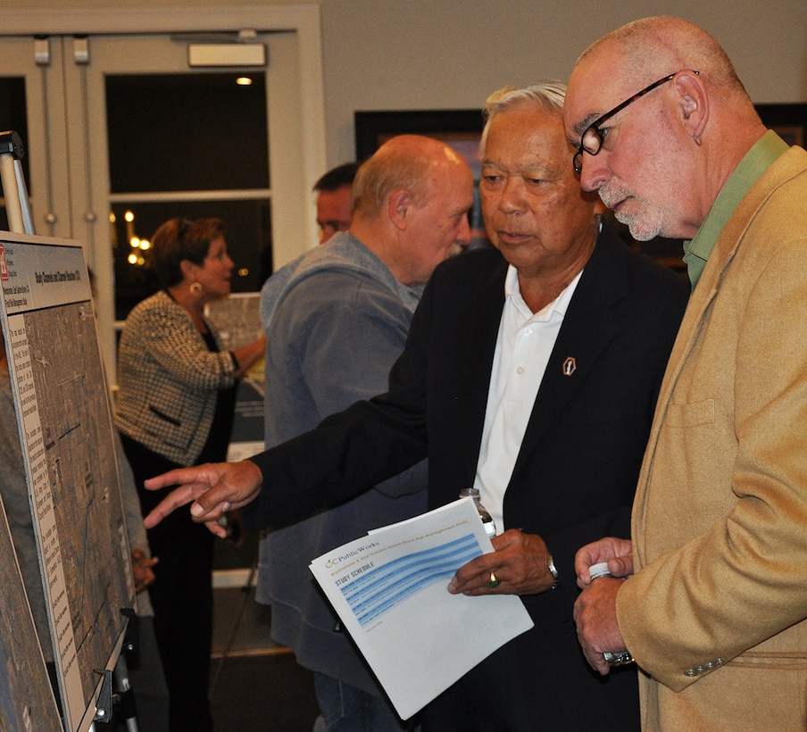 Community members who live in the Westminster Watershed look over maps of a proposed project to reduce flood risk in their area during a Nov. 8 public meeting about the Westminster/East Garden Grove Flood Risk Management Study in Huntington Beach, California.