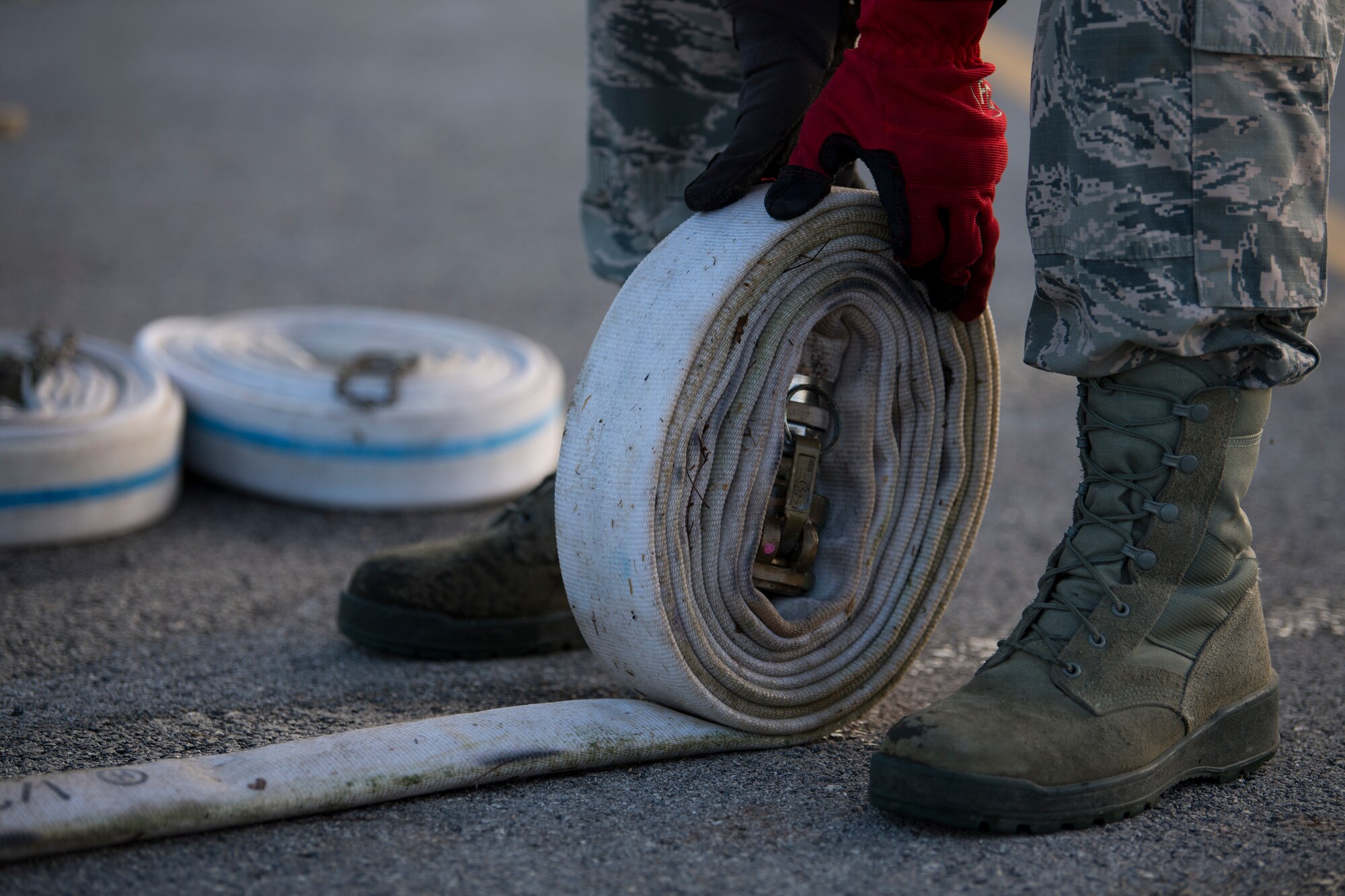 Staff Sgt. Martin Figueroa Ortiz, 36th Civil Engineer Squadron electrical systems maintainer assigned to Andersen Air Base, Guam, rolls up a hose during reverse osmosis water purification unit tear down on Saipan, Commonwealth of the Northern Mariana Islands, Nov. 21, 2018, as part of the Super Typhoon Yutu relief effort.