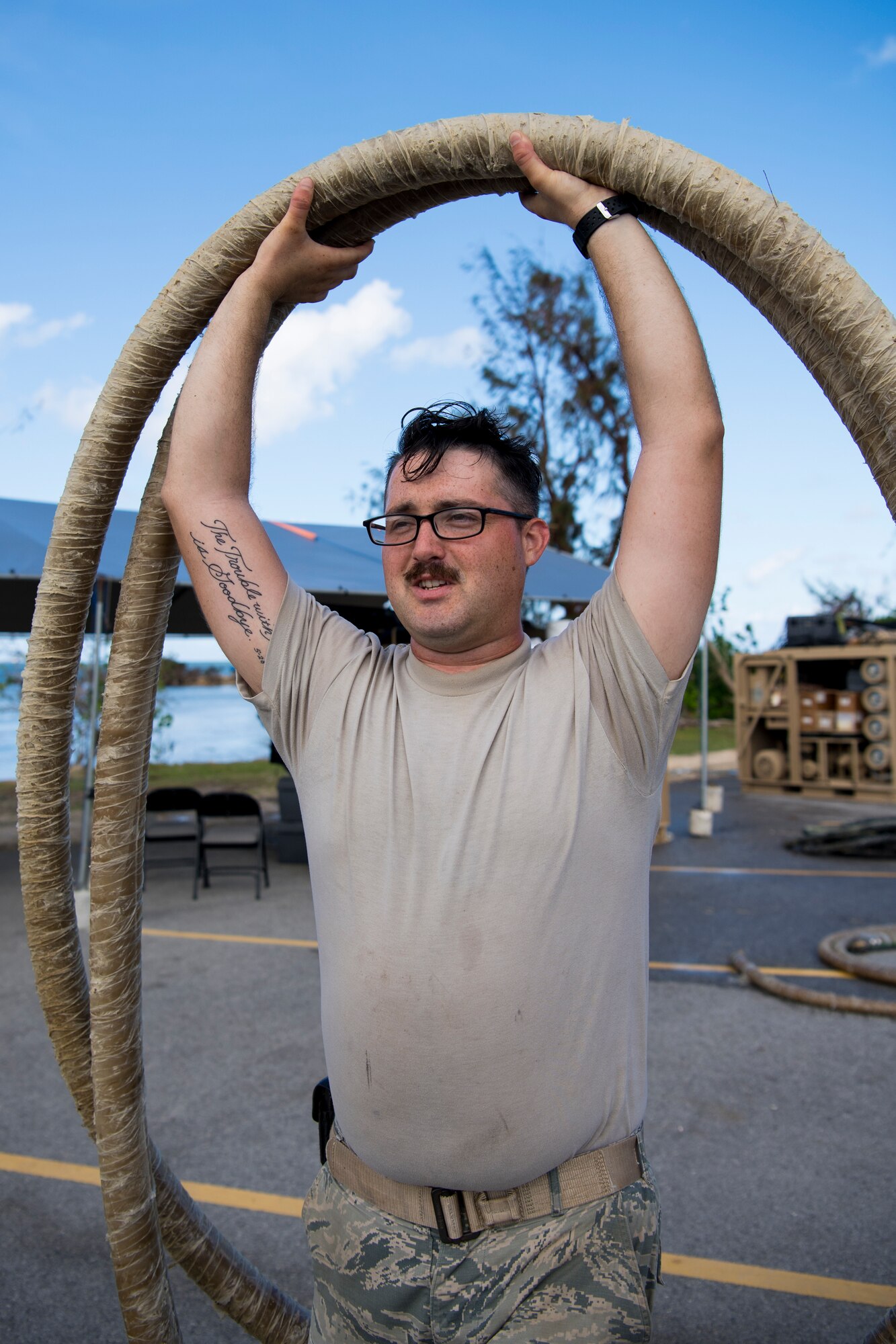 Senior Airman John McGovney, 36th Civil Engineer Squadron water and fuel systems maintainer assigned to Andersen Air Base, Guam, carries a hose during reverse osmosis water purification unit tear down on Saipan, Commonwealth of the Northern Mariana Islands, Nov. 21, 2018, as part of the Super Typhoon Yutu relief effort.