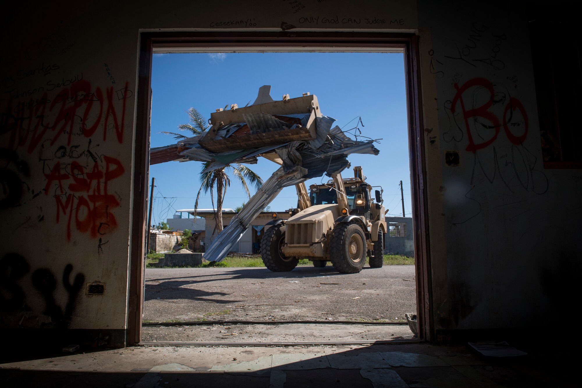 Pvt. Joseph Mafnas, 1224th Engineer Support Company, uses a high mobility evacuation equipment vehicle to remove debris from a street in the village of Chalan Kanoa, Saipan, Commonwealth of the Northern Mariana Islands, Nov. 20, 2018.