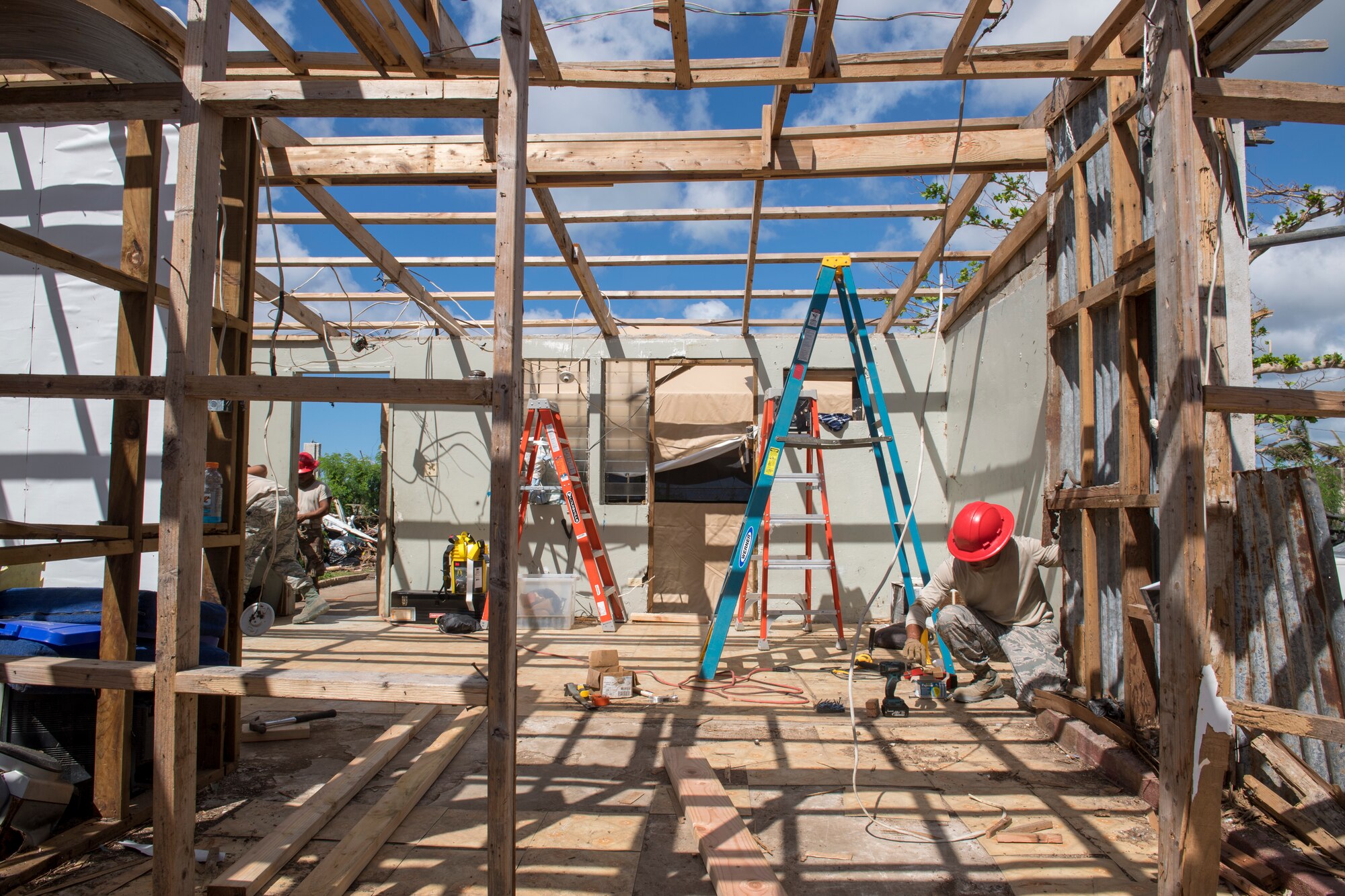 Tech. Sgt. Andy Quintanilla, 254th Rapid Engineer Deployable Heavy Operational Repair Squadron Engineers structural craftsman, builds a roof for a home in the village of Koblerville, Saipan, Commonwealth of the Northern Mariana Islands, Nov. 20, 2018, as part of the roof building in support of the Super Typhoon Yutu relief efforts.