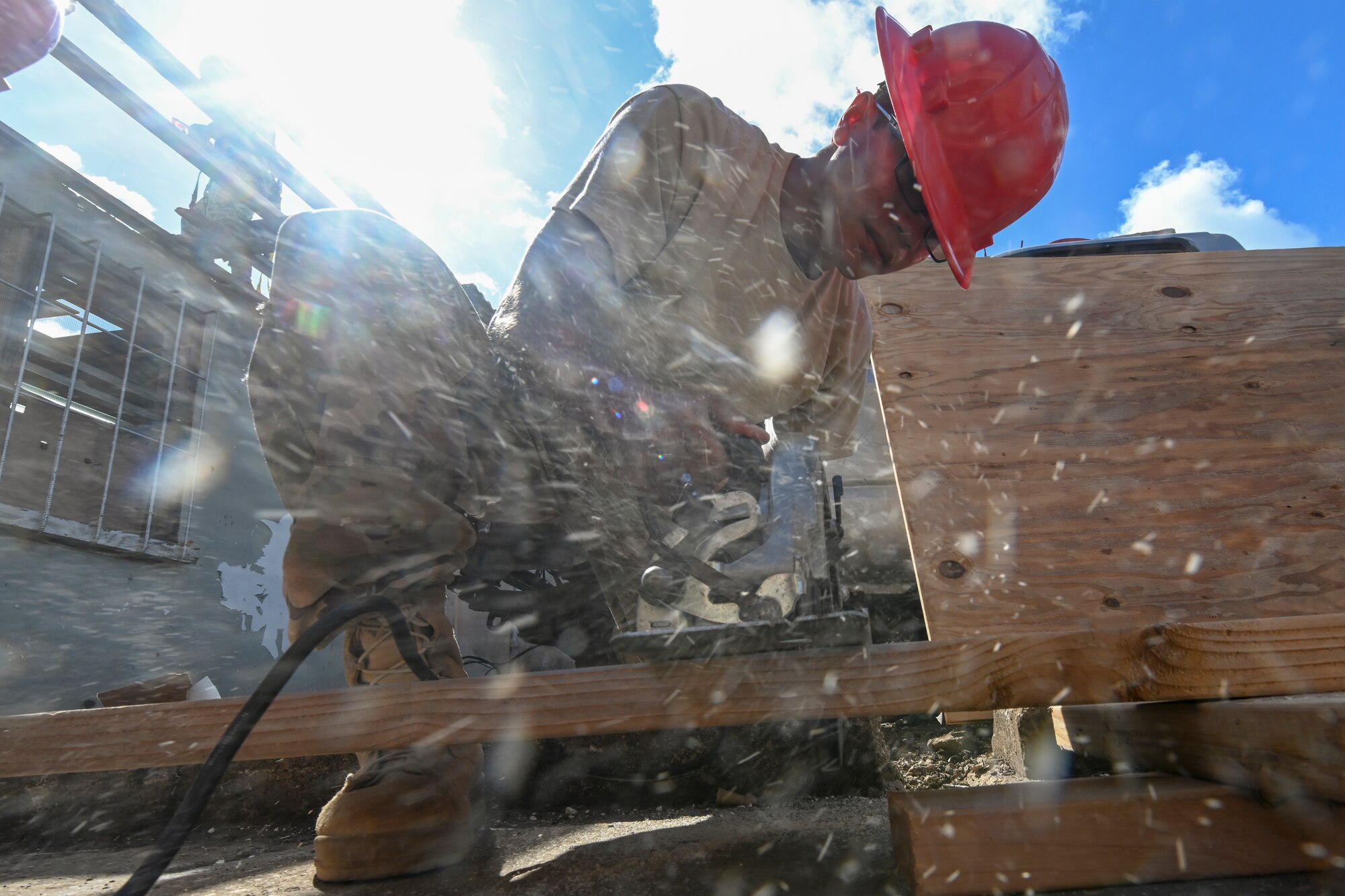 Staff Sgt. Pete Taijeron, 254th Rapid Engineer Deployable Heavy Operational Repair Squadron Engineers, uses a circular saw to cut a piece of 2x4 that will be used to help build a roof for a home in the village of Koblerville, Saipan, Commonwealth of the Northern Mariana Islands, Nov. 20, 2018, as part of the roof building in support of the Super Typhoon Yutu relief efforts.