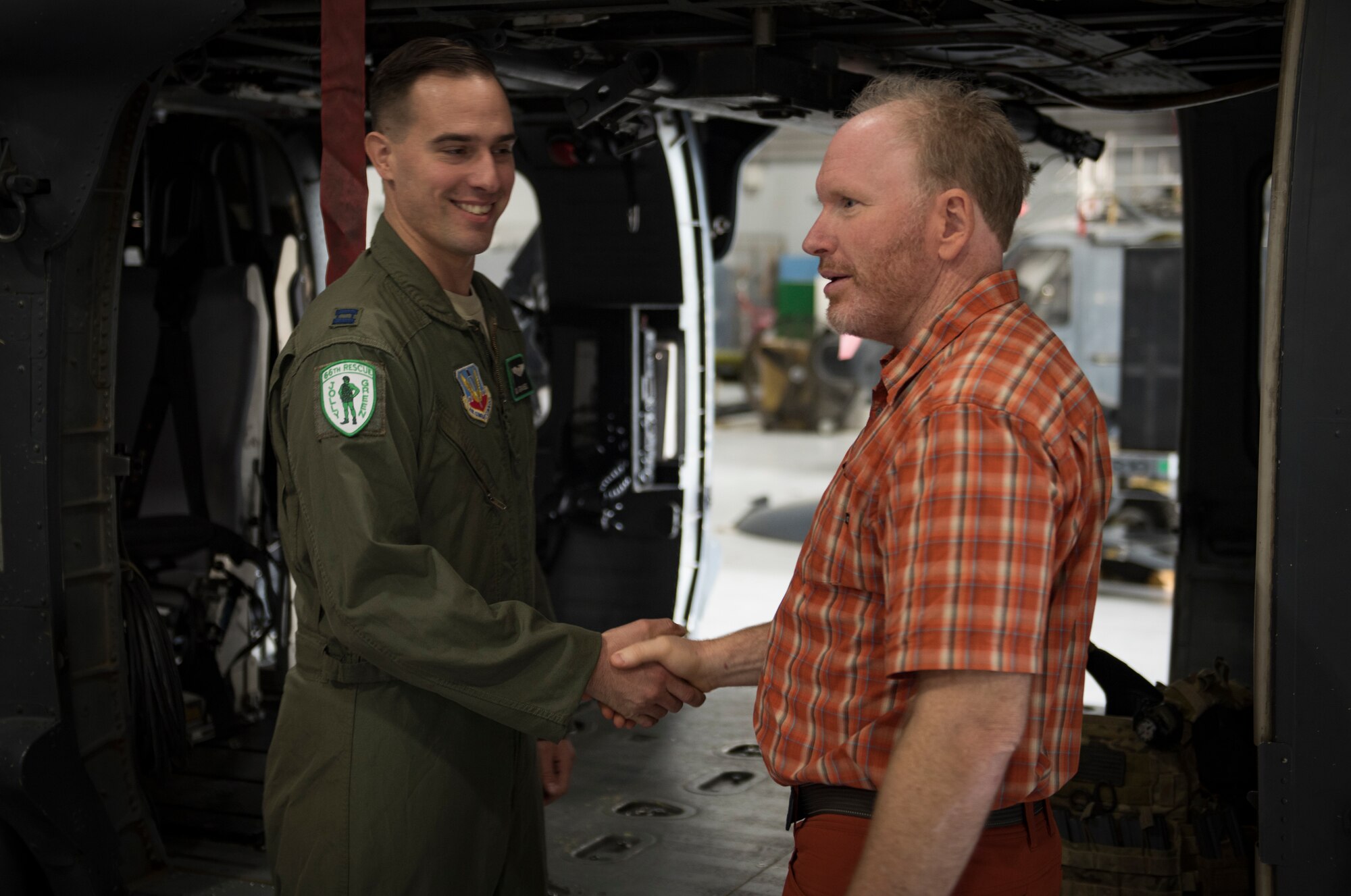 Capt. Ben Gransee, 66th Rescue Squadron HH-60G Pave Hawk helicopter pilot, meets Dr. Daniel Cottam, a bariatric surgeon from Salt Lake City, Utah, at Nellis Air Force Base, Nevada, Nov. 16, 2018. Gransee piloted the helicopter that rescued Cottam after he was severely injured after falling off a cliff when his climbing equipment malfunctioned. (U.S. Air Force photo by Airman 1st Class Andrew D. Sarver)