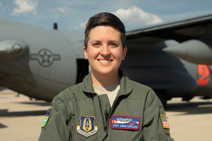 C-130J loadmaster, poses for a photo in front of her aircraft