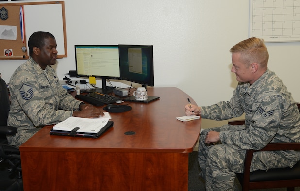 Master Sgt. Jason Greenwell, Career Assistance Advisor, and Senior Airman Jacob Minter, 912th Aircraft Maintenance Squadraon, discuss possible career options at Edwards Air Force Base, California, Nov. 8. (U.S. Air Force photo by Giancarlo Casem)