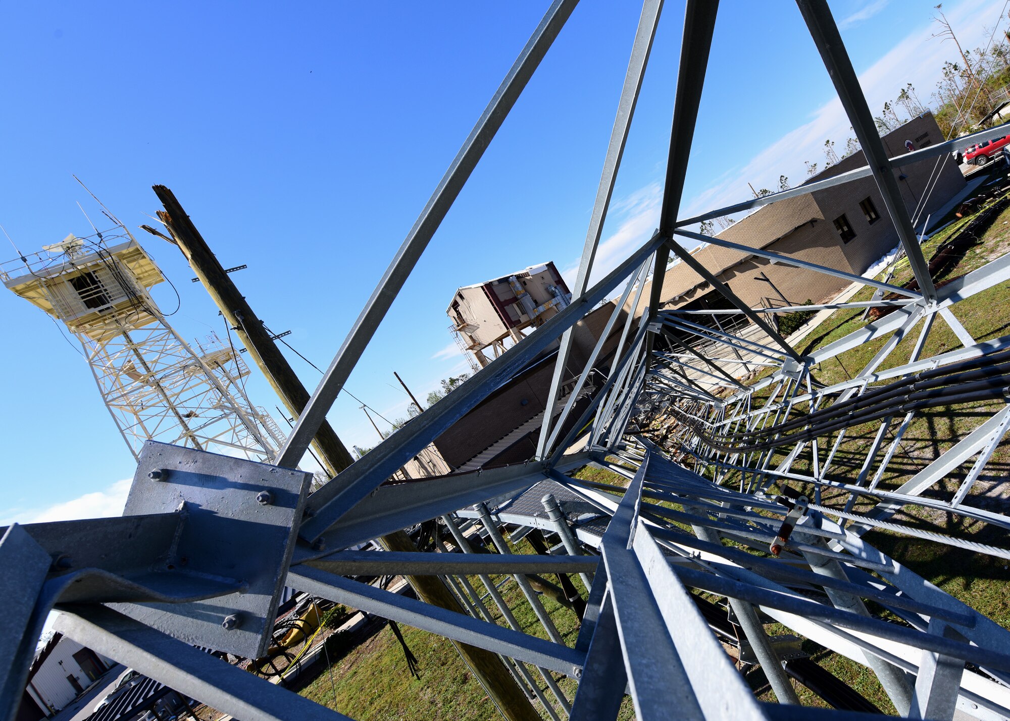 A fallen communication tower lays at the foot of the 81st Range Control Squadron at Tyndall Air Force Base, Fla., Nov. 19, 2018. Despite Hurricane Michael leaving destruction in its wake, the 81st RCS was brought back online and provided command and control for the first live mission in the skies over the Tyndall Range Complex. (U.S. Air Force photo by Senior Airman Isaiah J. Soliz)