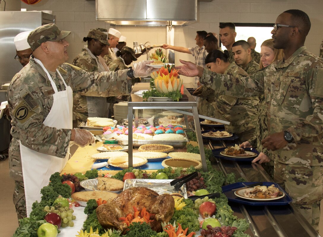 Navy Adm. Kurt W. Tidd, Commander, U.S. Southern Command, visited Joint Task Force Guantanamo Troopers to celebrate the Thanksgiving holiday as one of his final acts as commander, Nov. 22. Tidd was joined by incoming SOUTHCOM Commander, Navy Adm. Craig S. Faller; Marine Sgt. Maj. Bryan K. Zickefoose, SOUTHCOM Command Senior Enlisted Leader; and JTF GTMO leaders, to visit Troopers on duty and serve Thanksgiving lunch at the Camp America Galley.