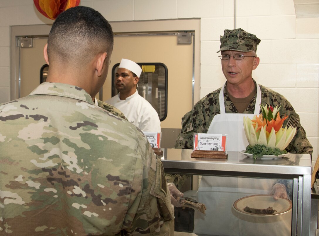 Navy Adm. Kurt W. Tidd, Commander, U.S. Southern Command, visited Joint Task Force Guantanamo Troopers to celebrate the Thanksgiving holiday as one of his final acts as commander, Nov. 22. Tidd was joined by incoming SOUTHCOM Commander, Navy Adm. Craig S. Faller; Marine Sgt. Maj. Bryan K. Zickefoose, SOUTHCOM Command Senior Enlisted Leader; and JTF GTMO leaders, to visit Troopers on duty and serve Thanksgiving lunch at the Camp America Galley.