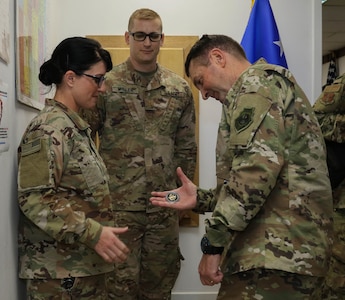 Air Force National Guard Gen. Joseph Lengyel, right, chief of the National Guard Bureau, awards U.S. Army National Guard Sgt. 1st Class Karmen Walling, human resources sergeant assigned to Headquarters and Support Company, 935th Aviation Support Battalion, from Springfield, Missouri, a coin at the 35th Combat Aviation Brigade’s Administrative and Logistical Operations Center at Camp Buehring, Kuwait, Nov. 22, 2018.