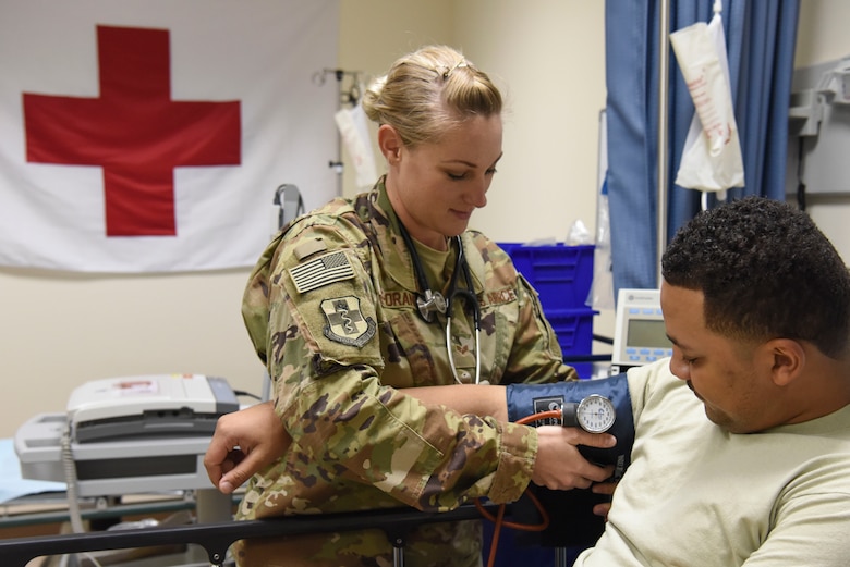 Senior Airman Stephanie Poe-Orange, 380th Expeditionary Medical Group aerospace medical technician, checks the blood pressure of a patient at Al Dhafra Air Base, United Arab Emirates, Nov. 21, 2018.