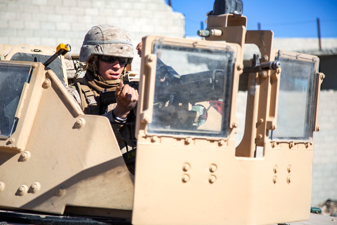 Pfc. Pierre Marthe prepares to fire an M240B machine gun during urban effects training on Camp Wilson, Marine Corps Air Ground Combat Center Twentynine Palms, California, Nov. 12, 2018. Marines with Transportation Services Company, Combat Logistics Battalion 4, Combat Logistics Regiment 3, 3rd Marine Logistics Group, maneuvered through a simulated combat town with vehicles in order to improve efficiency in combat environments. ITX 1-19 is a large-scale Marine Air-Ground Task Force integration exercise in which CLB-4 Marines and Sailors train to respond quickly to any contingency by fully integrating with ground and air combat elements of the MAGTF. Marthe is a native of Wrightwood, California.  (U.S. Marine Corps photo by Cpl. Joshua Pinkney)