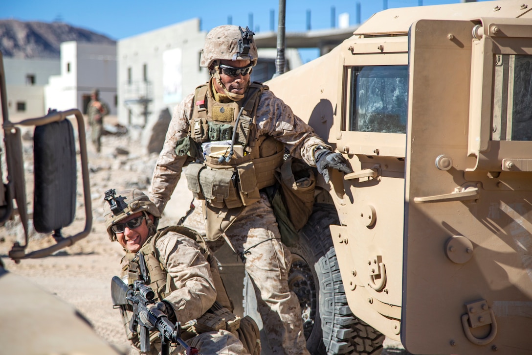 Staff Sgt. Andre Stephens, left, drags Cpl. Benjamin Lammers to a Humvee after Lammers suffers a simulated injury during urban effects training on Camp Wilson, Marine Corps Air Ground Combat Center Twentynine Palms, California, Nov. 12, 2018. Marines with Transportation Services Company, Combat Logistics Battalion 4, Combat Logistics Regiment 3, 3rd Marine Logistics Group, maneuvered through a simulated combat town with vehicles in order to improve efficiency in combat environments. ITX 1-19 is a large-scale Marine Air-Ground Task Force integration exercise in which CLB-4 Marines and Sailors train to respond quickly to any contingency by fully integrating with ground and air combat elements of the MAGTF. Stephens is a native of St. Thomas, Jamaica. Lammers is a native of Springfield, Missouri. (U.S. Marine Corps photo by Cpl. Joshua Pinkney)