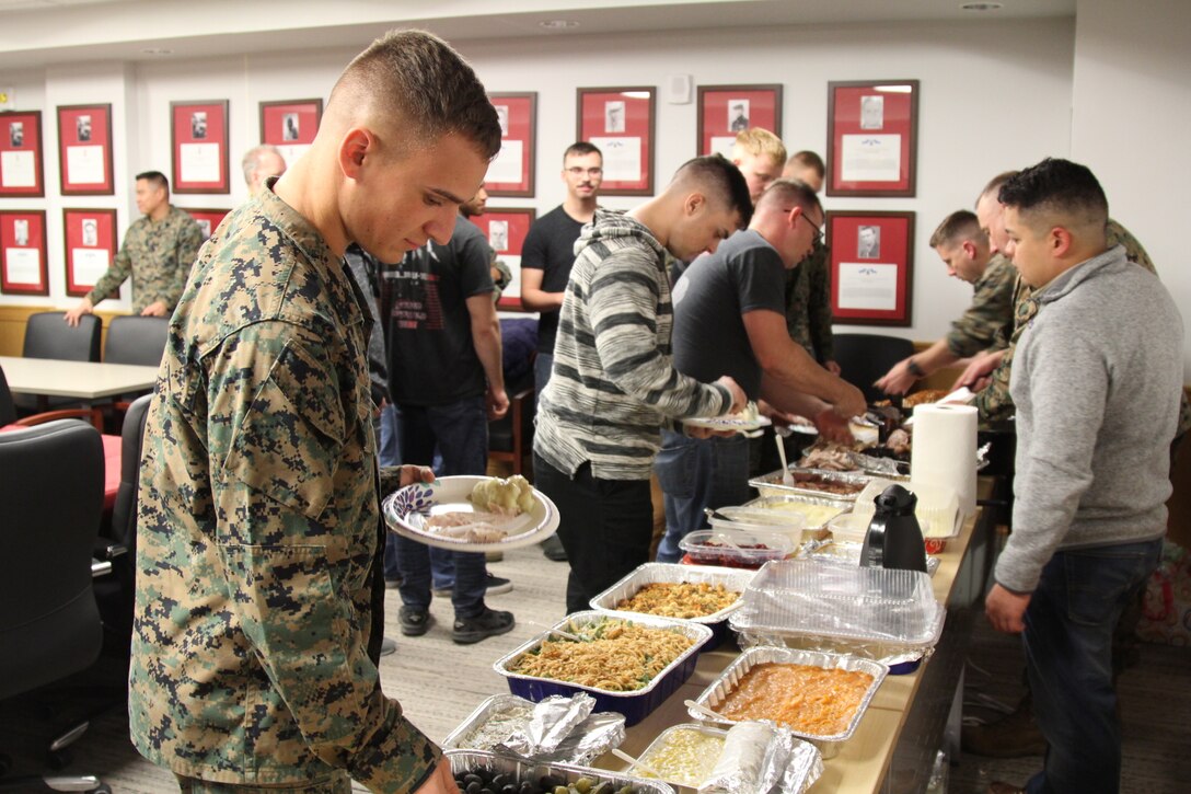 CAMP HUMPHREYS, Republic of Korea - U.S. Marine Corps Forces Korea Marines enjoy their Thanksgiving Meal provided by the spouses of Marines from across the combined joint services here, Nov. 21.  The Marine spouses wanted the Marines to have a nice home cooked meal as a team before departing for the holiday. (Official U.S. Marine Corps photos by Capt. John Parry/Released)