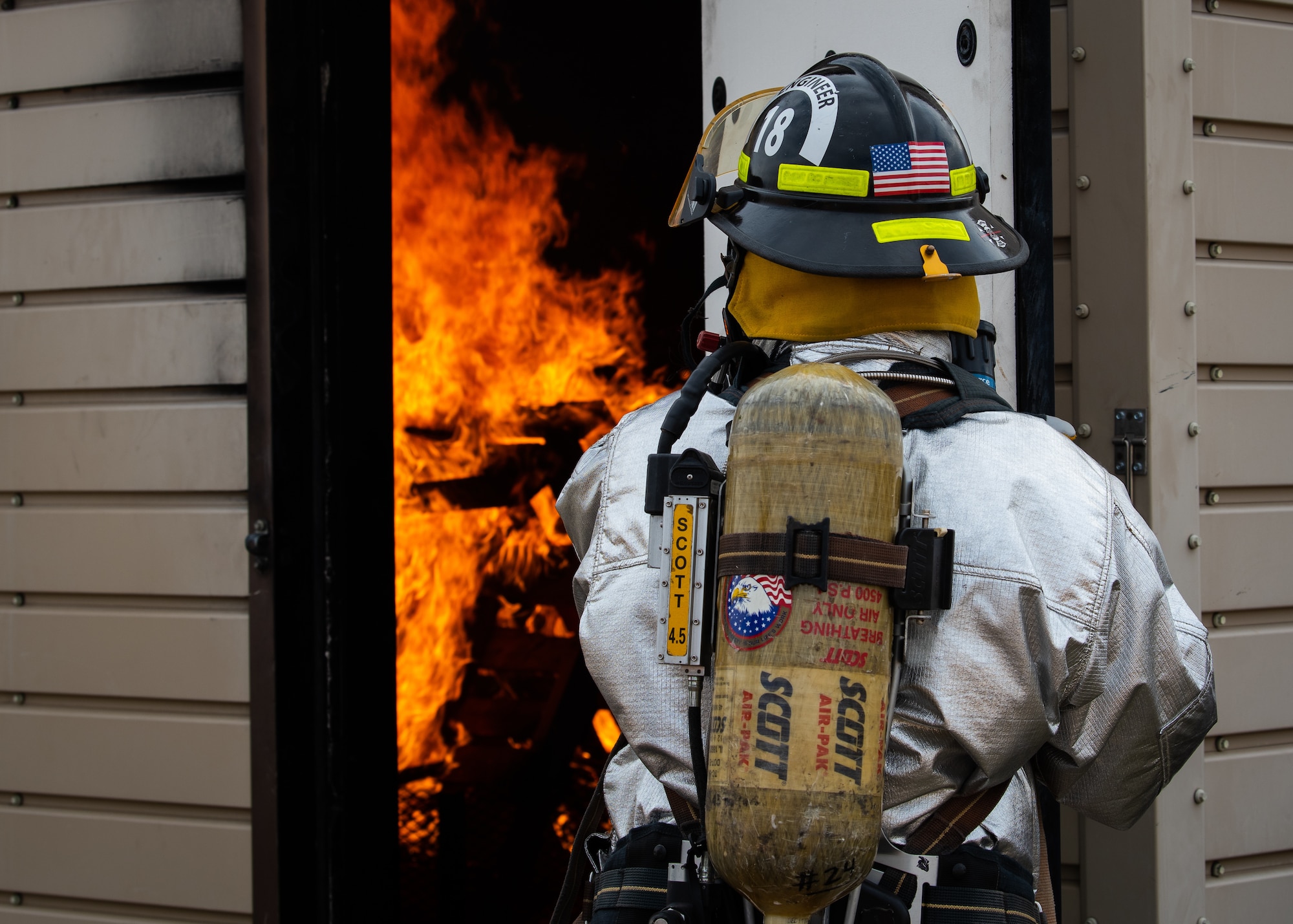 A Gila Bend Air Force Auxiliary Field firefighter holds a door open during a joint aircraft and structural fire training, Nov. 14, 2018 at Luke Air Force Base, Ariz.