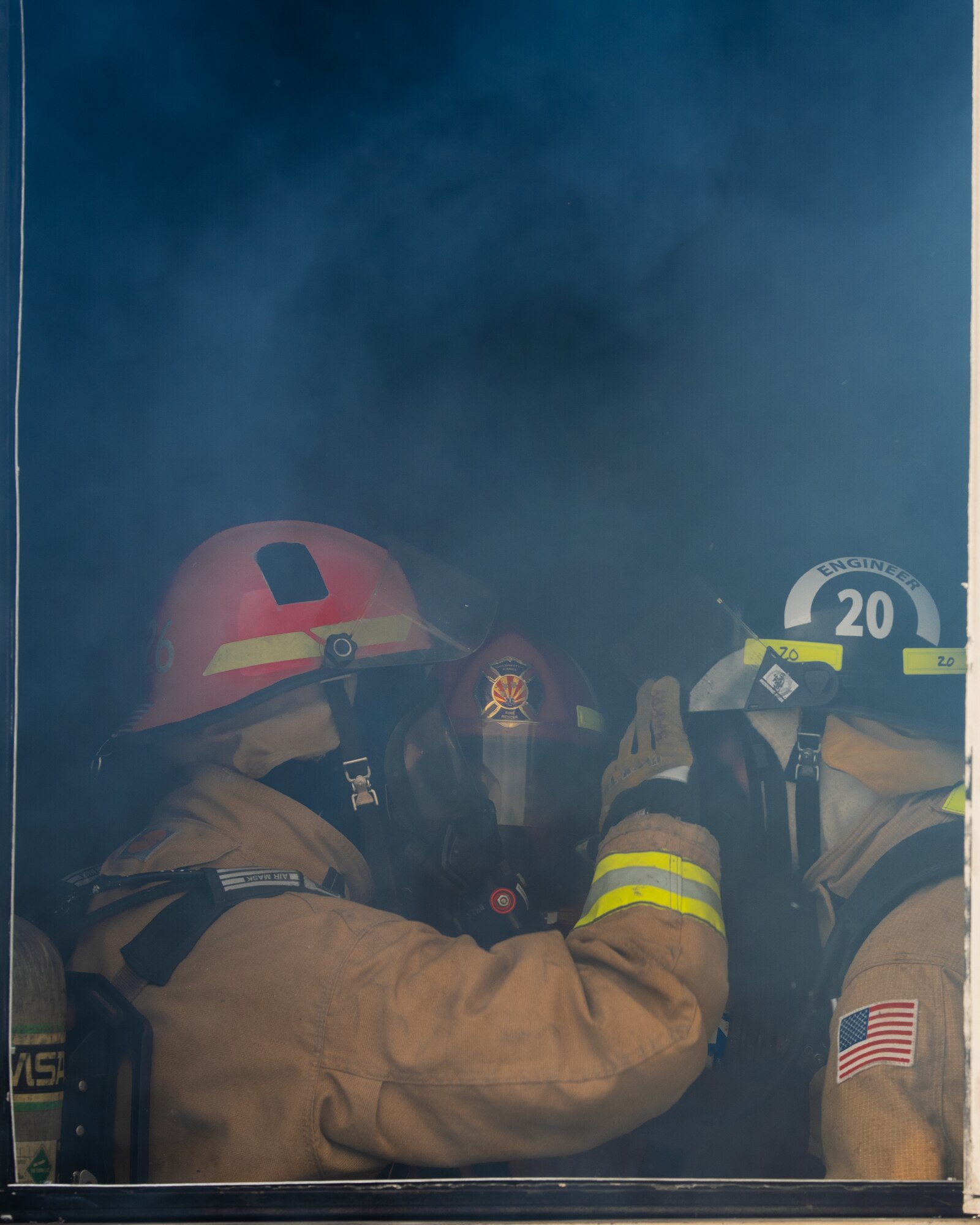 56th Civil Engineer Squadron firefighters perform gear checks next to an open window during a joint aircraft and structural fire training, Nov. 14, 2018 at Luke Air Force Base, Ariz.