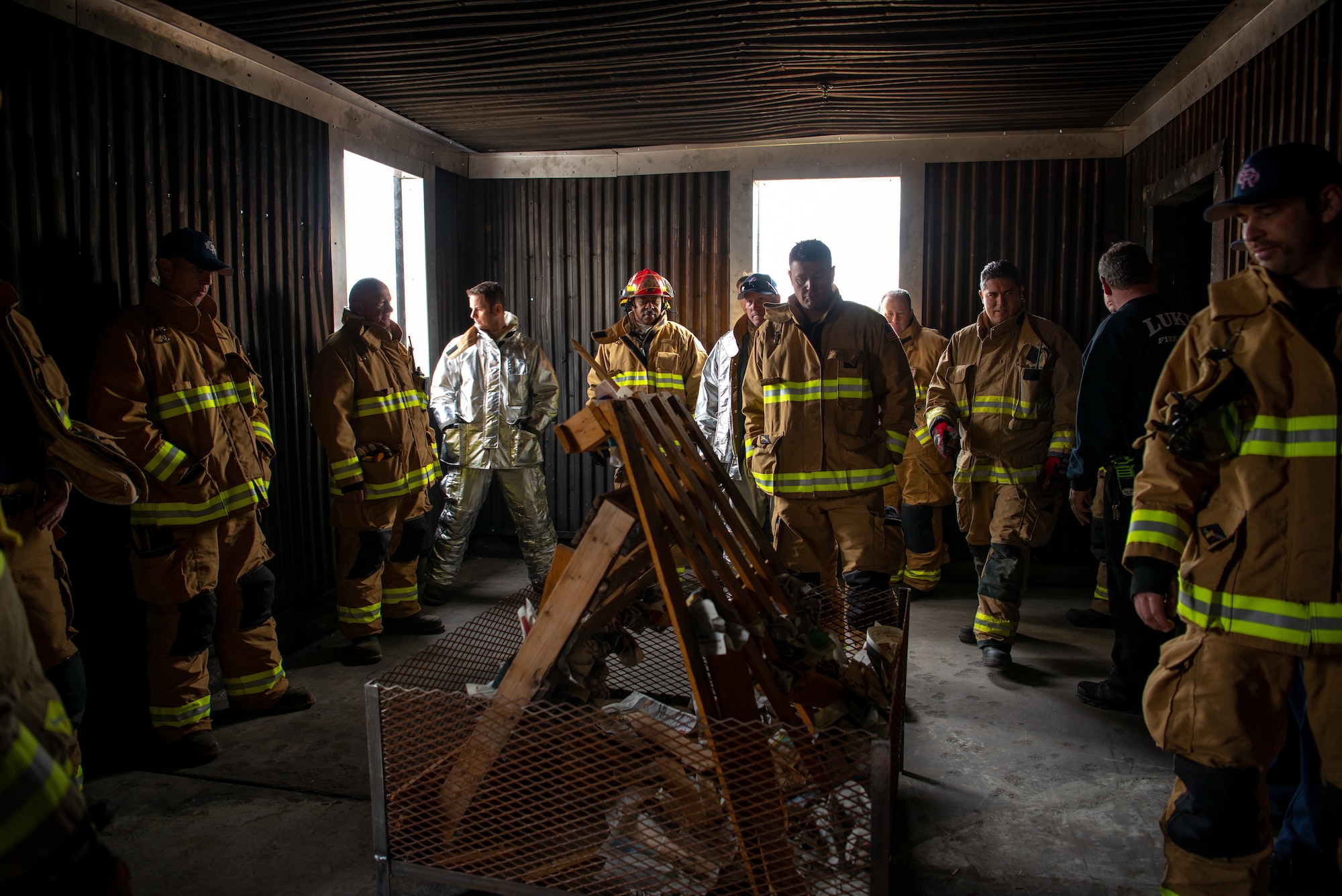 Luke firefighters assigned to the 56th Civil Engineer Squadron Fire Department and Gila Bend Air Force Auxiliary Field, listen to a safety brief before igniting a training structural fire, Nov. 14, 2018 at Luke Air Force Base, Ariz.
