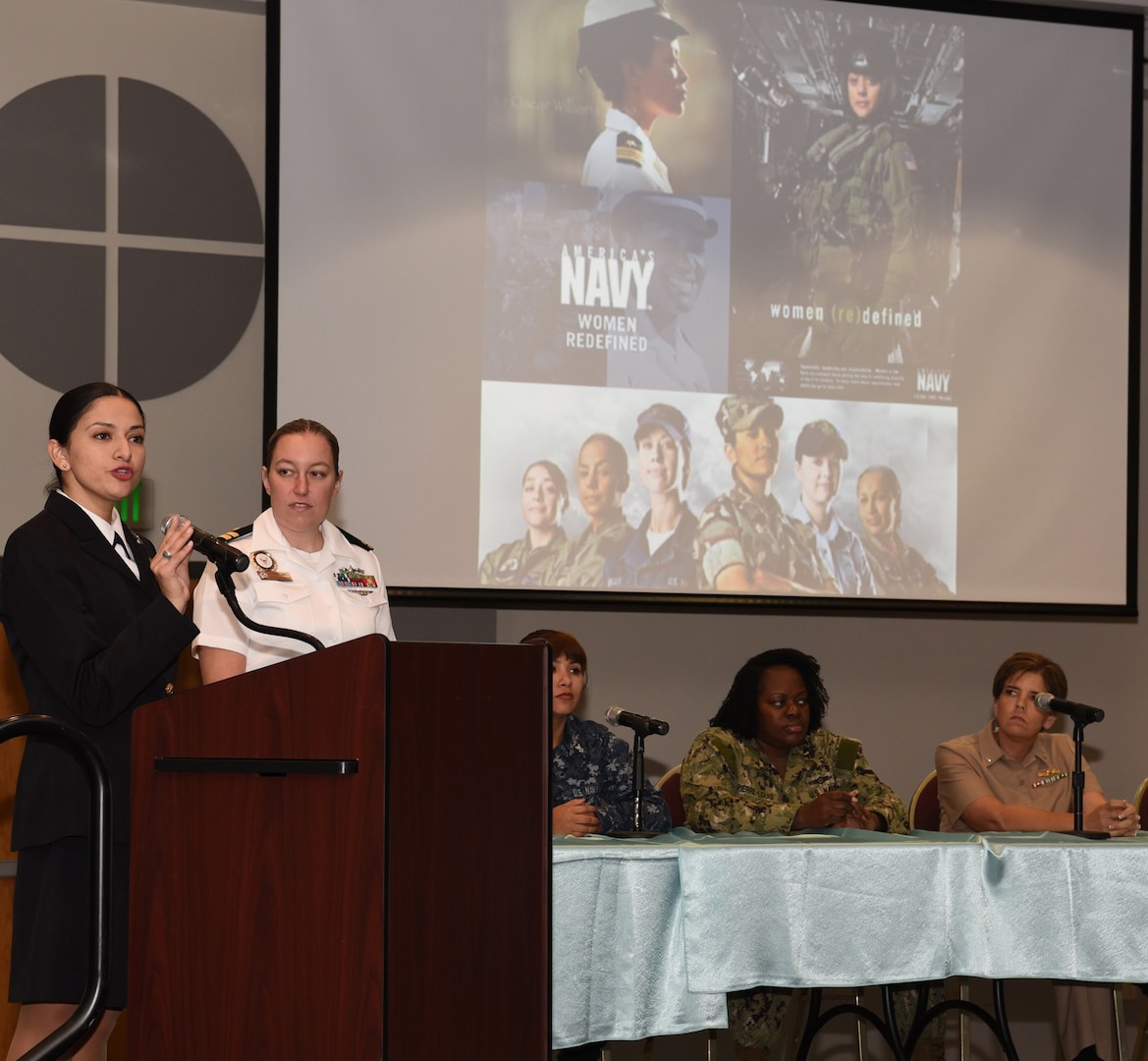 Chief Petty Officer Isabel Guerrero, Division 6 leading chief petty officer, is joined by Division 6 officer Lt. Amy Zabel, both assigned to Navy Recruiting District San Antonio, to address more than 80 future Sailors, parents and supporters during an All-Female Delayed Entry Program and Key Influencer Meeting held at the Rosenberg Sky Room on the campus of the University of the Incarnate Word in San Antonio.