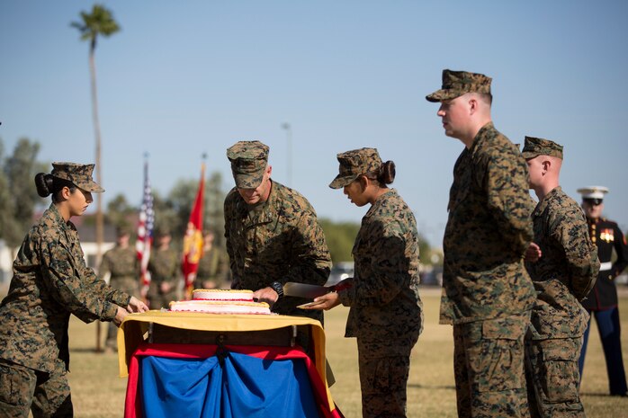 U.S. Marine Corps Col. David A. Suggs, commanding officer, Marine Corps Air Station Yuma, cuts the cake during the 243rd Marine Corps birthday uniform pageant at the Parade Deck on Marine Corps Air Station Yuma, Ariz., Nov. 8, 2018. The annual ceremony was held in honor of the 243rd Marine Corps birthday, showcasing historical uniforms to honor Marines of the past, present and future while signifying the passing of traditions from one generation to the next. (U.S. Marine Corps photo by Sgt. Allison Lotz)