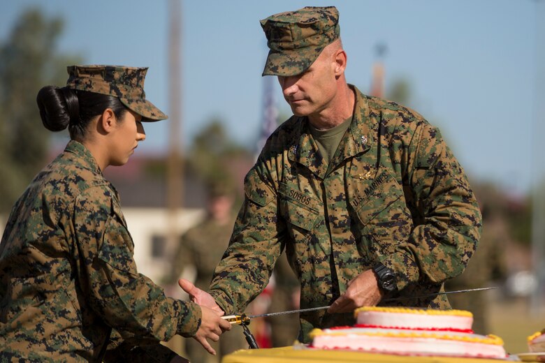 U.S. Marine Corps Col. David A. Suggs, commanding officer, Marine Corps Air Station Yuma, cuts the cake during the 243rd Marine Corps birthday uniform pageant at the Parade Deck on Marine Corps Air Station Yuma, Ariz., Nov. 8, 2018. The annual ceremony was held in honor of the 243rd Marine Corps birthday, showcasing historical uniforms to honor Marines of the past, present and future while signifying the passing of traditions from one generation to the next. (U.S. Marine Corps photo by Sgt. Allison Lotz)