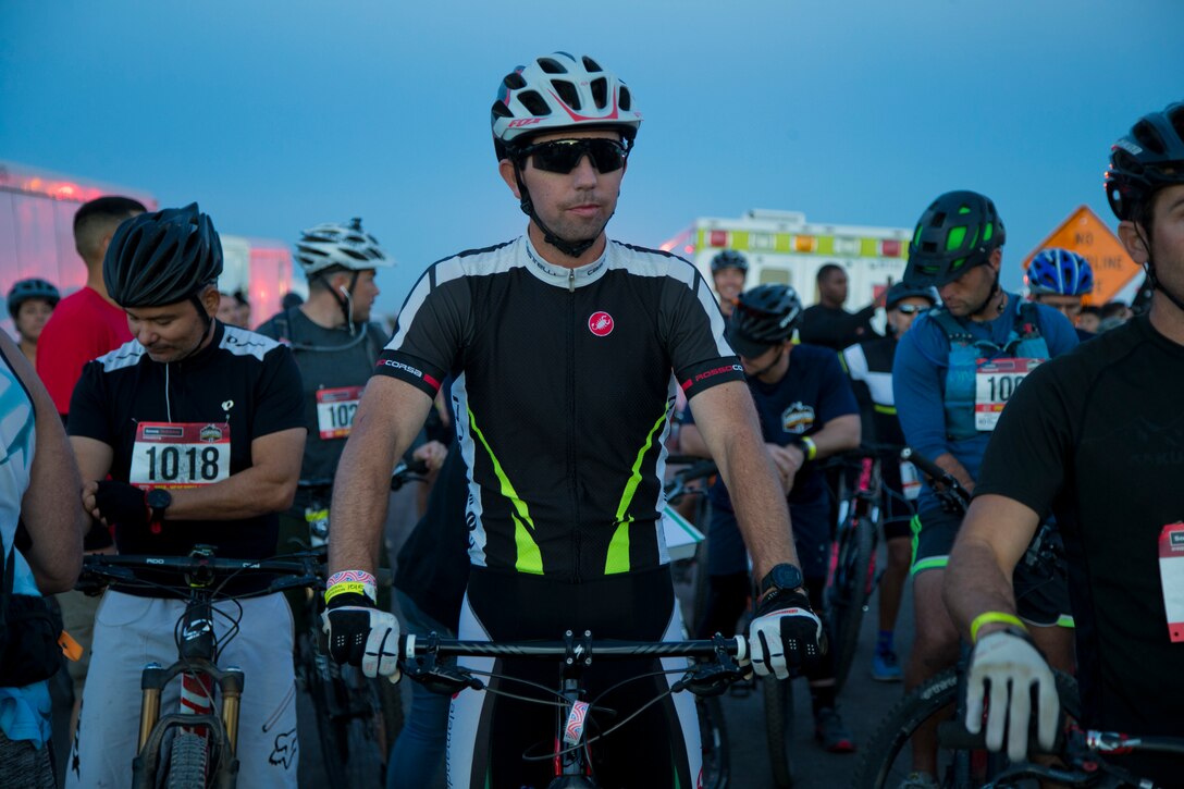 A competitor within the bike route participates in the first annual Telegraph Pass Challenge in Yuma, Ariz., Nov. 3, 2018. The challenge, coordinated by Marine Corps Community Services (MCCS), offered participants the opportunity to compete for first, second, or third place in either a 5 mile run, 5 mile bike route, or both. The course included a "Blue Mile" which is typically the most difficult portion of the racing event being a silent mile. The "Blue Mile" honors and remembers all fallen heroes of the Military, Police, and Fire Department. (U.S. Marine Corps photo by Lance Cpl. Joel Soriano)