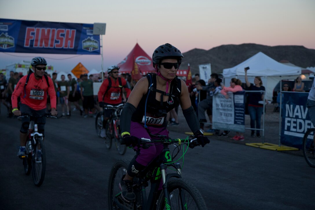 A competitor within the bike route participates in the first annual Telegraph Pass Challenge in Yuma, Ariz., Nov. 3, 2018. The challenge, coordinated by Marine Corps Community Services (MCCS), offered participants the opportunity to compete for first, second, or third place in either a 5 mile run, 5 mile bike route, or both. The course included a "Blue Mile" which is typically the most difficult portion of the racing event being a silent mile. The "Blue Mile" honors and remembers all fallen heroes of the Military, Police, and Fire Department. (U.S. Marine Corps photo by Lance Cpl. Joel Soriano)