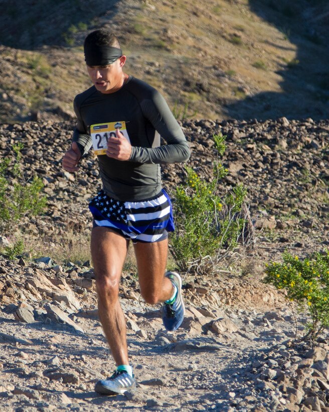 A competitor within the run route participates in the first annual Telegraph Pass Challenge in Yuma, Ariz., Nov. 3, 2018. The challenge, coordinated by Marine Corps Community Services (MCCS), offered participants the opportunity to compete for first, second, or third place in either a 5 mile run, 5 mile bike route, or both. The course included a "Blue Mile" which is typically the most difficult portion of the racing event being a silent mile. The "Blue Mile" honors and remembers all fallen heroes of the Military, Police, and Fire Department. (U.S. Marine Corps photo by Lance Cpl. Joel Soriano)