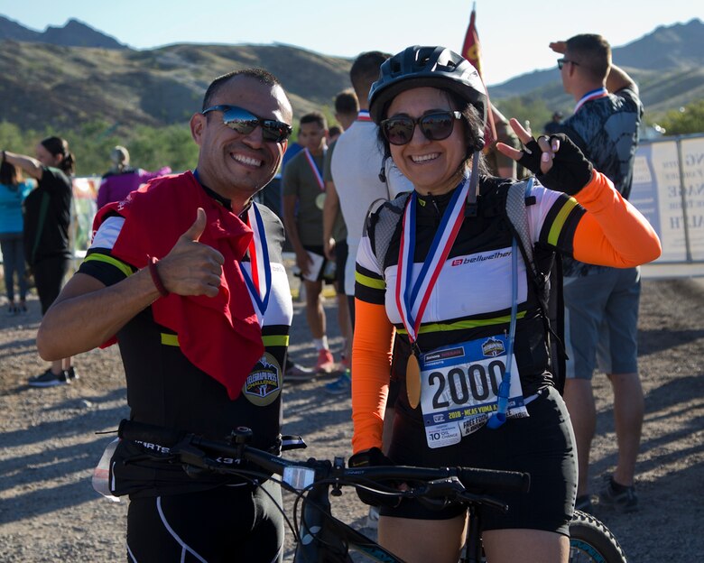 Competitors within the bike route pose for a photo after participating in the first annual Telegraph Pass Challenge in Yuma, Ariz., Nov. 3, 2018. The challenge, coordinated by Marine Corps Community Services (MCCS), offered participants the opportunity to compete for first, second, or third place in either a 5 mile run, 5 mile bike route, or both. The course included a "Blue Mile" which is typically the most difficult portion of the racing event being a silent mile. The "Blue Mile" honors and remembers all fallen heroes of the Military, Police, and Fire Department. (U.S. Marine Corps photo by Lance Cpl. Joel Soriano)
