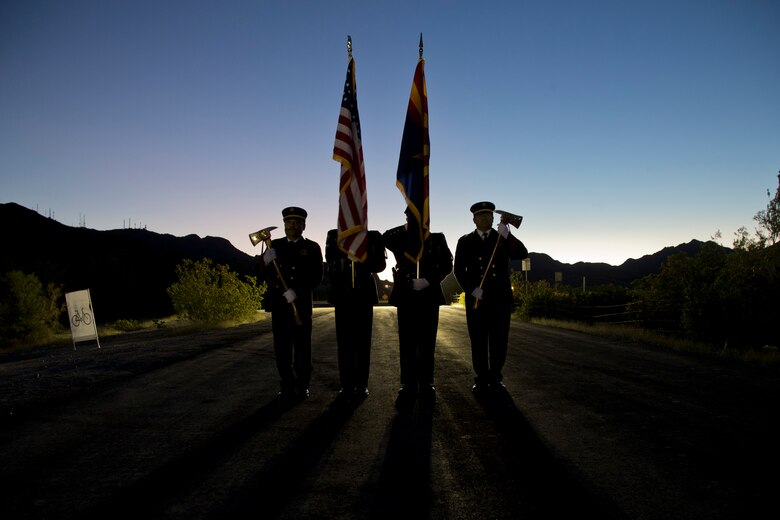 The Yuma Police and Fire Department present the colors during the first annual Telegraph Pass Challenge in Yuma, Ariz., Nov. 3, 2018. The challenge, coordinated by Marine Corps Community Services (MCCS), offered participants the opportunity to compete for first, second, or third place in either a 5 mile run, 5 mile bike route, or both. The course included a "Blue Mile" which is typically the most difficult portion of the racing event being a silent mile. The "Blue Mile" honors and remembers all fallen heroes of the Military, Police, and Fire Department. (U.S. Marine Corps photo by Lance Cpl. Joel Soriano)