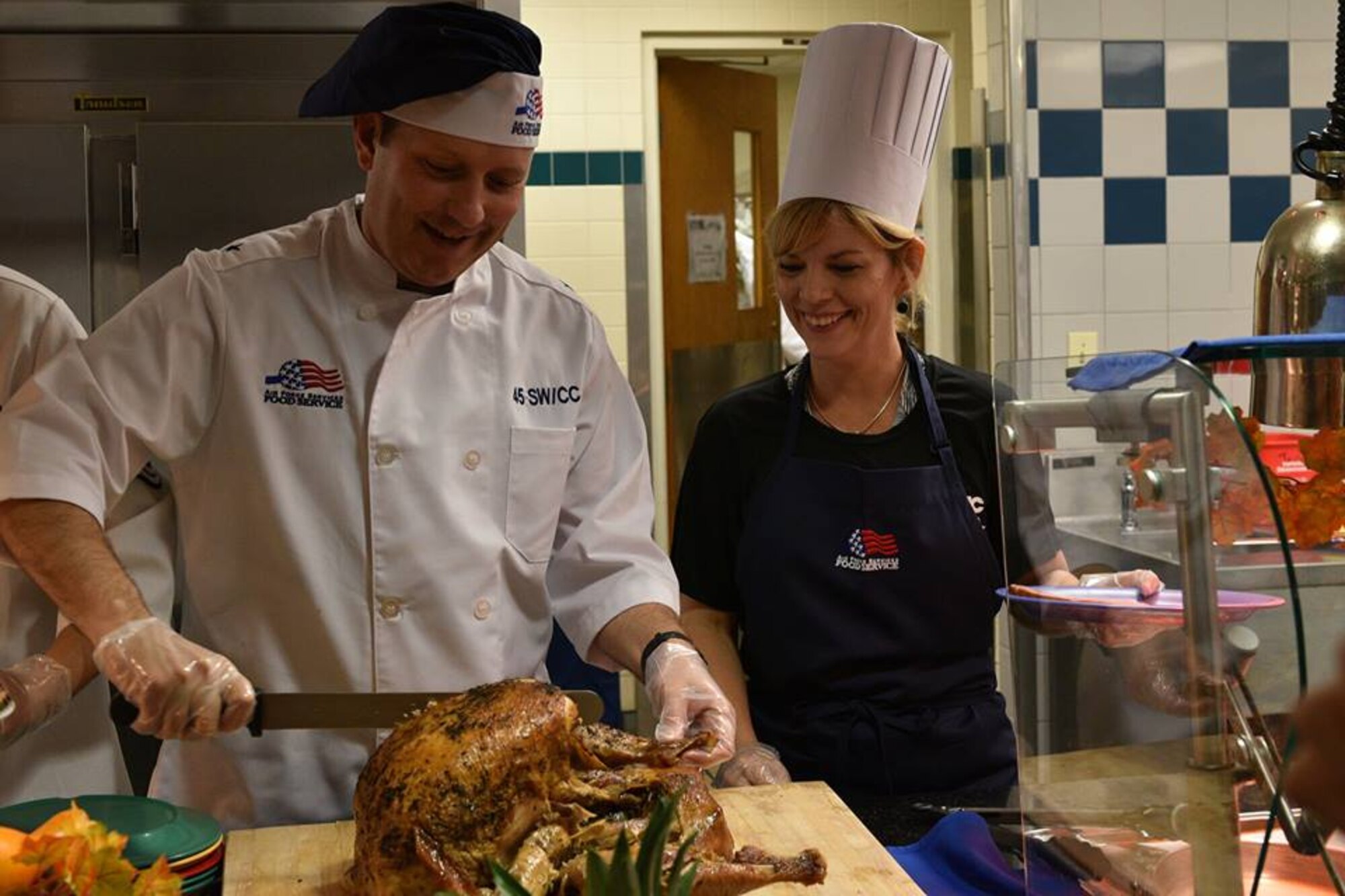 Brig. Gen. Doug Schiess, 45th Space Wing commander, and his wife Debbie, volunteer to feed the base community at the Patrick Air Force Base Riverside Dining Facility, on Nov. 22, 2018. Airmen live by their core values, and the 45th SW leadership demonstrated Air Force core values by serving our community meals during the Thanksgiving holiday.