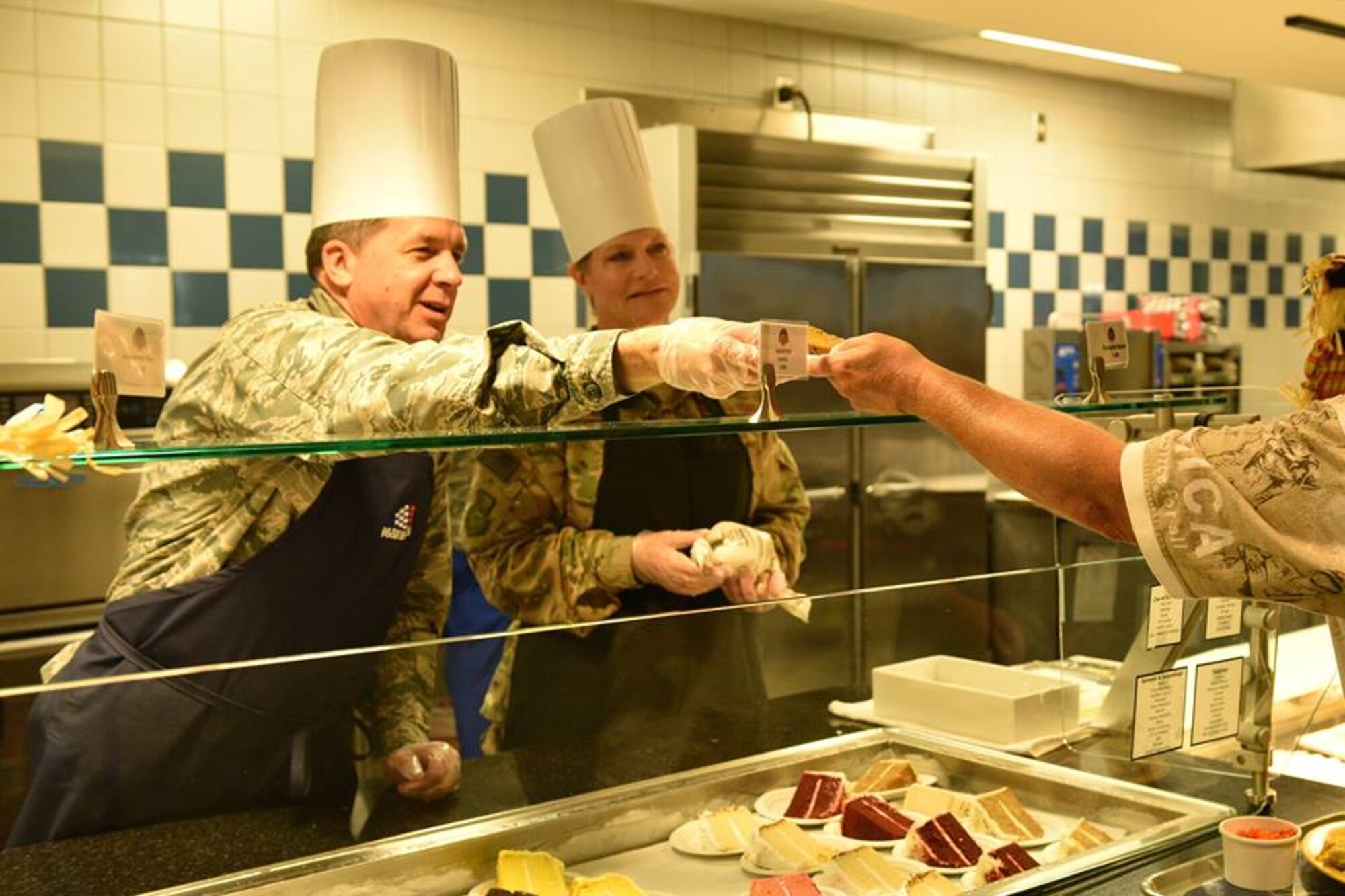 Col. Donald Shannon, 45th Weather Squadron commander, and Maj. Dawn Baker, 45th Launch Readiness Squadron commander, serve a Thanksgiving meal at Patrick Air Force Base Riverside Dining Facility on Nov. 22, 2018. Airmen live by their core values, and the 45th SW leadership demonstrated Air Force core values by serving our community meals during the Thanksgiving holiday.
