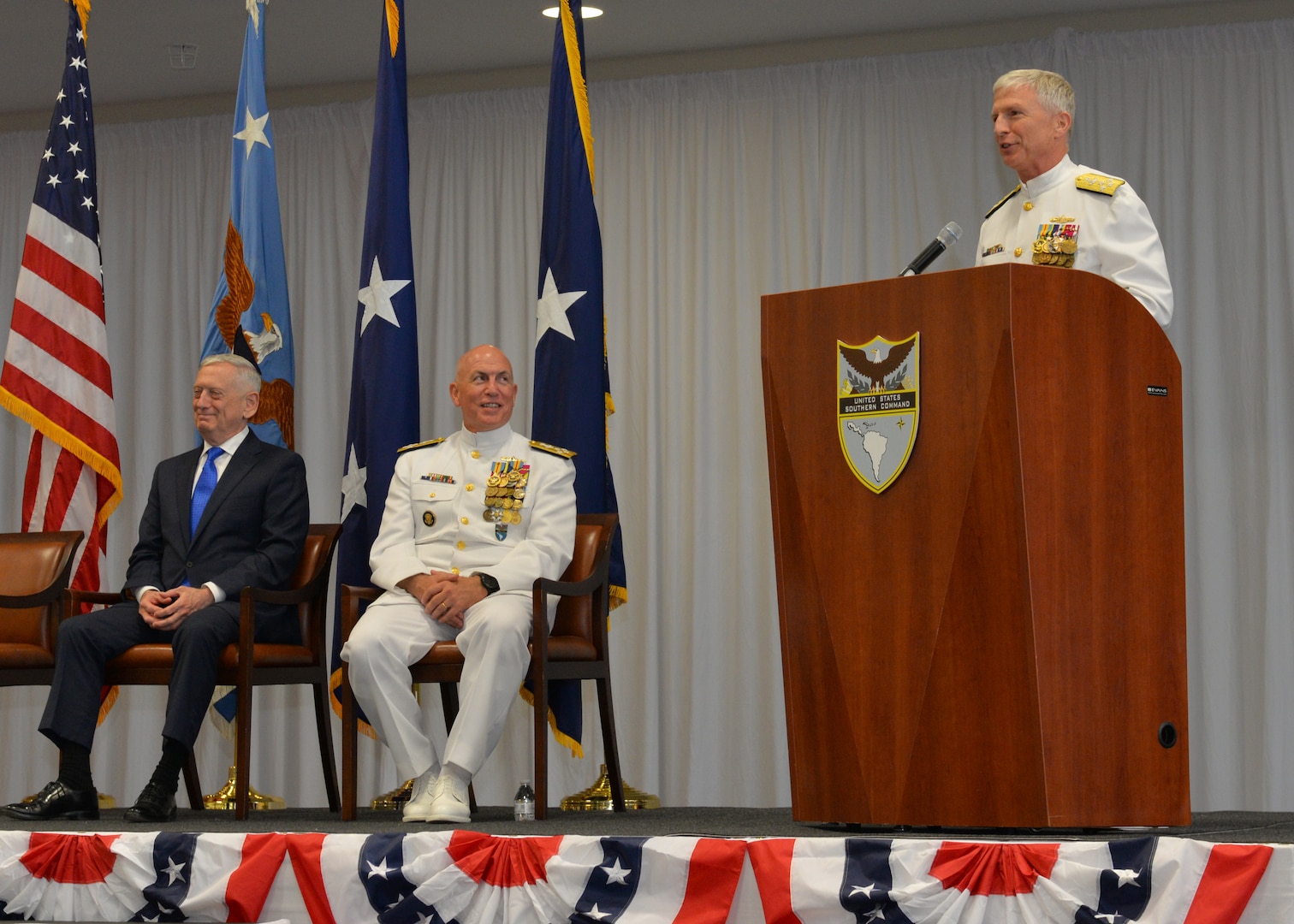 Adm. Craig S. Faller, USN, right, incoming commander of U.S. Southern Command, addresses the audience during the change of command ceremony change of command ceremony held at SOUTHCOM's headquarters in Miami, Fla.