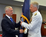 U.S. Secretary of Defense James Mattis, left, passes the U.S. Southern Command guidon to Adm. Craig S. Faller, USN, incoming commander of SOUTHCOM.