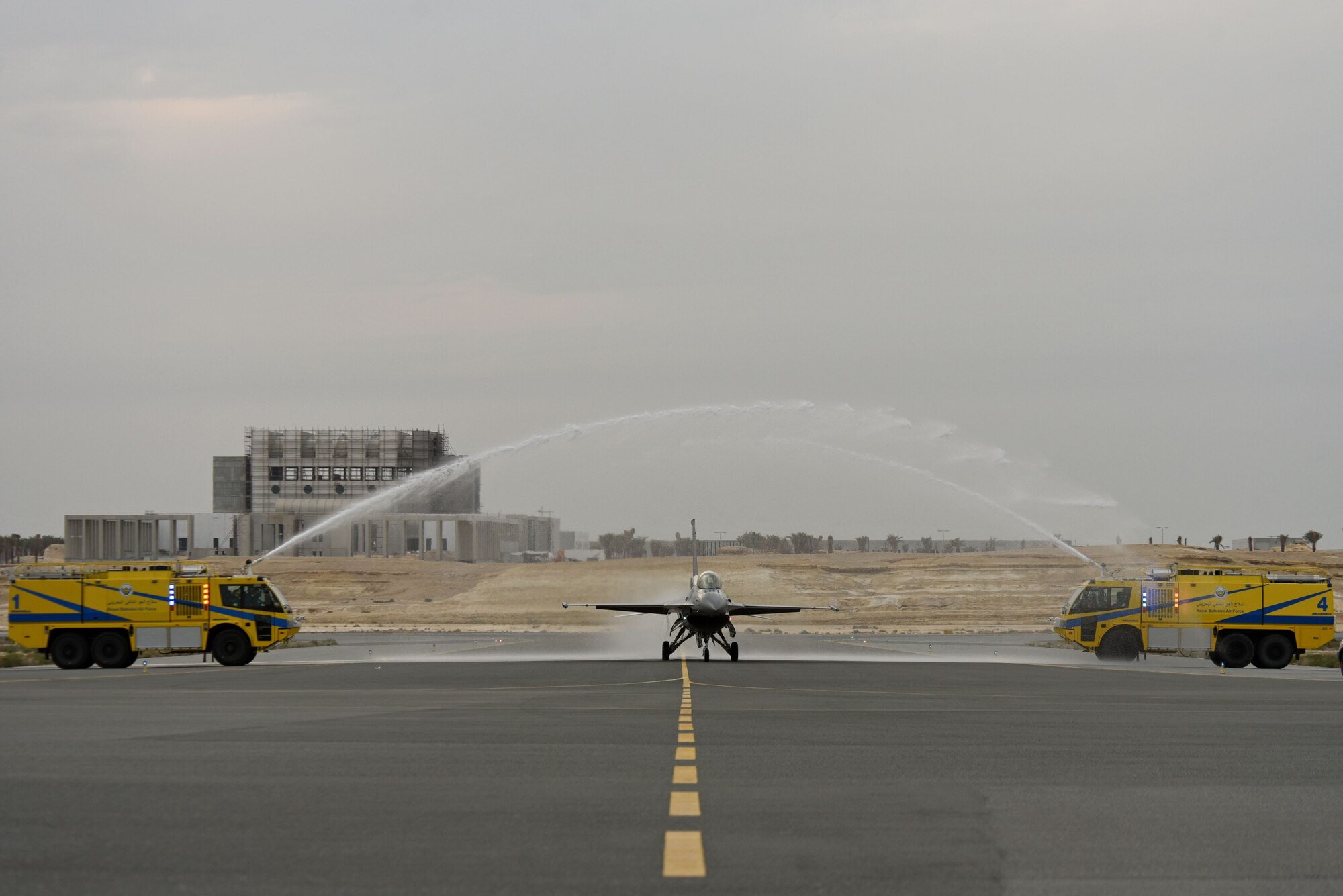 U.S. Air Force Maj. John “Rain” Waters, F-16 Viper Demonstration Team (VDT) commander and pilot, taxis an F-16CM Fighting Falcon, “Viper,” between firetrucks on the flight line at Sakhir Airbase, Kingdom of Bahrain, Nov. 16, 2018.