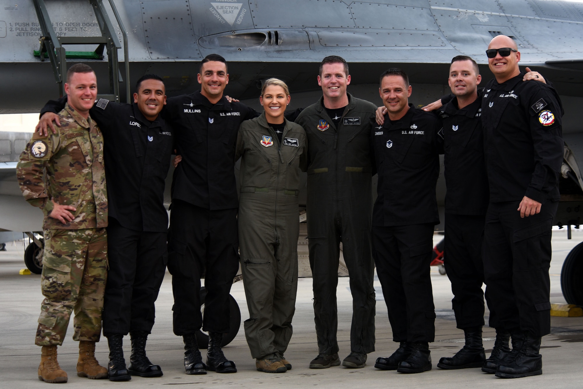 U.S. Airmen assigned to the Air Combat Command F-16 Viper Demonstration Team stand together on the flight line at Sakhir Airbase, Kingdom of Bahrain, Nov. 16, 2018.