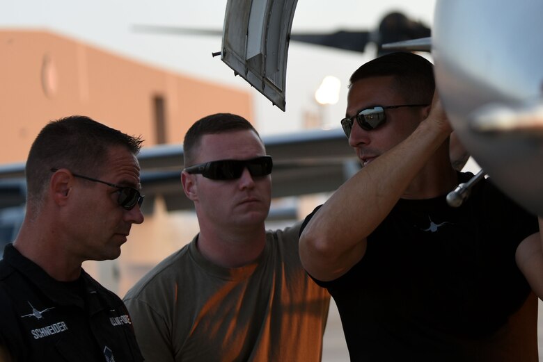 (From left) U.S. Air Force Master Sgt. Chris Schneider, F-16 Viper Demonstration Team (VDT) superintendent, Tech. Sgt. Ryan Hutchinson, F-16 VDT assistant noncommissioned officer in charge, and Tech. Sgt. Stephen Mullins, F-16 VDT avionics specialist, discuss maintenance of an F-16CM Fighting Falcon following a Bahrain International Airshow demonstration flight at Sakhir Airbase, Kingdom of Bahrain, Nov. 14, 2018.