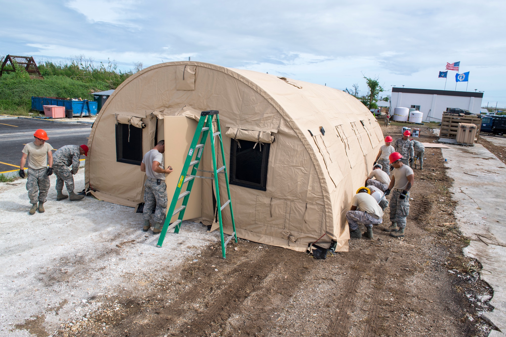 Members of the 254th Rapid Engineer Deployable Heavy Operational Repair Squadron Engineers and the 36th Civil Engineer Squadron build an Alaskan Small Shelter System in the village of Koblerville, Saipan, Commonwealth of the Northern Mariana Islands, Nov. 23, 2018.