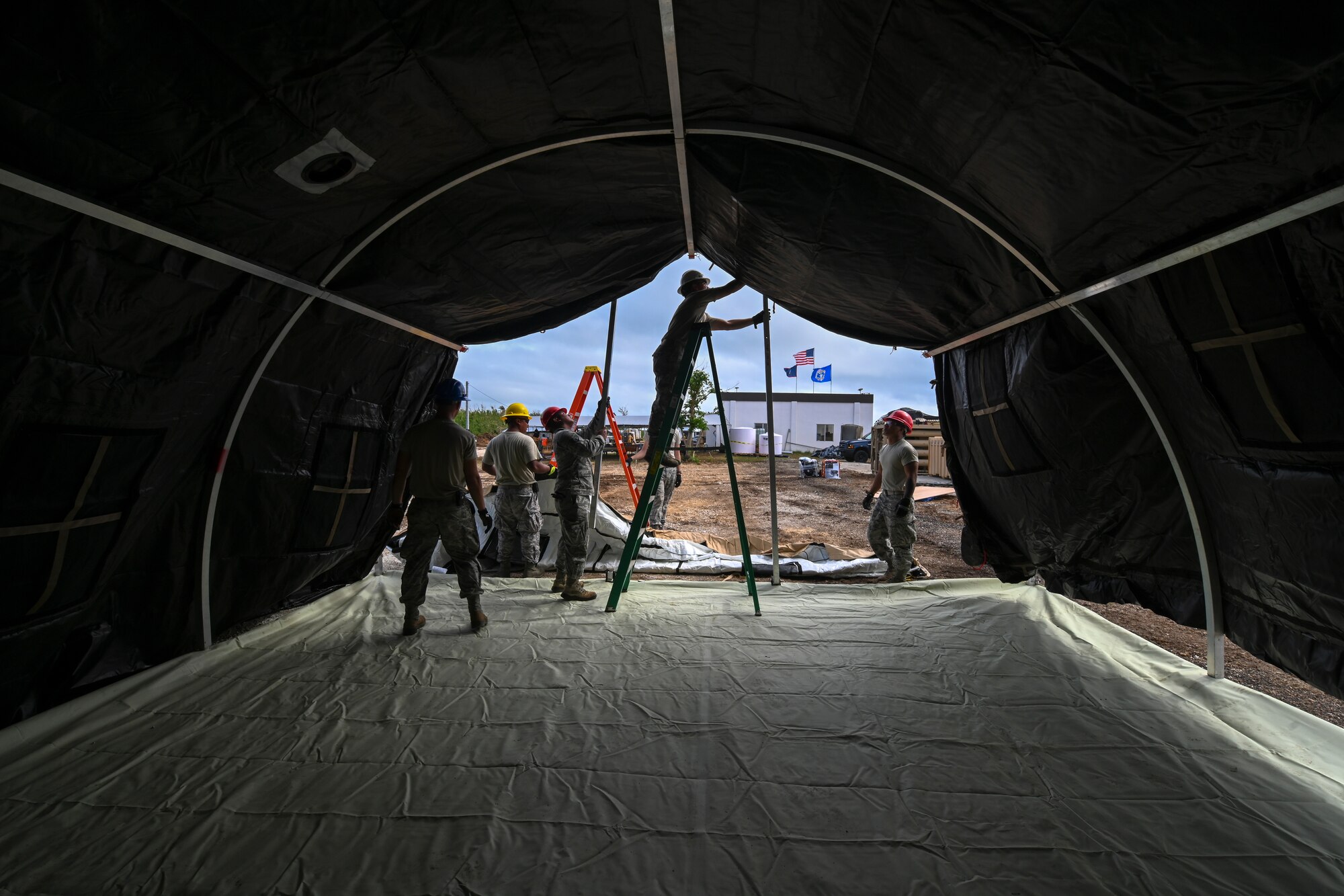 Members of the 254th Rapid Engineer Deployable Heavy Operational Repair Squadron Engineers and the 36th Civil Engineer Squadron erect a side wall for an  Alaskan Small Shelter System in the village of Koblerville, Saipan, Commonwealth of the Northern Mariana Islands, Nov. 23, 2018.
