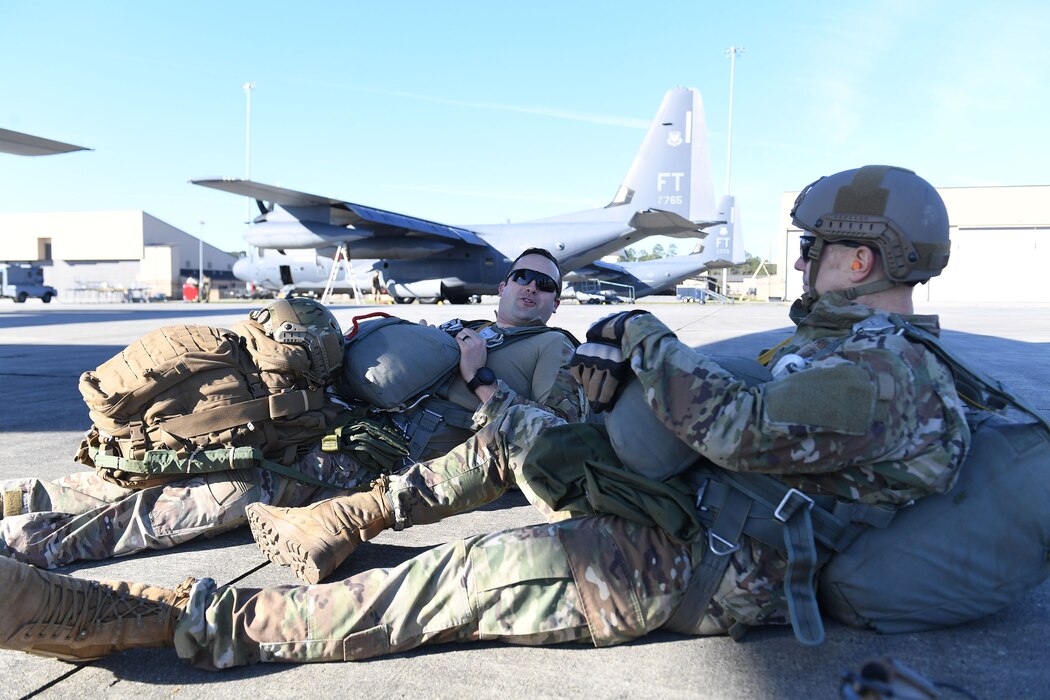 Col. Paul Birch (right), 93d Air Ground Operations Wing (AGOW) commander, talks with Capt. Jack Fine, 93d AGOW chief of next generation integration, on the flightline before boarding an HC-130J Combat King II prior to a static-line jump, Nov. 21, 2018, at Moody Air Force Base, Ga. The overall objective of the training was to increase jumpers’ skills, knowledge and proficiency in regards to airborne operations. During a static-line jump, the jumper is attached to the aircraft via the ‘static-line’, which automatically deploys the jumpers’ parachute after they’ve exited the aircraft. (U.S. Air Force photo by 1st Lt. Faith Brodkorb)