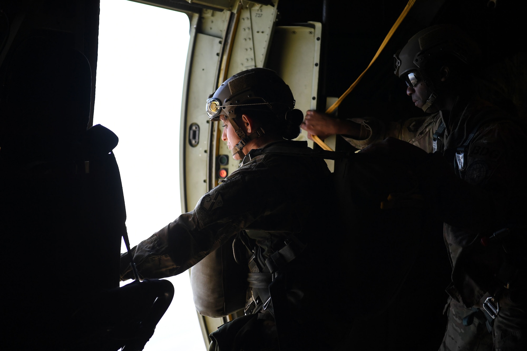Tech. Sgt. Cassandra Nagy, 93d Air Ground Operations Wing jumpmaster, approaches the door of a HC-130J Combat King II near Moody Air Force Base, Ga. The overall objective of the training was to increase jumpers’ skills, knowledge and proficiency in regards to airborne operations. During a static-line jump, the jumper is attached to the aircraft via the ‘static-line’, which automatically deploys the jumpers’ parachute after they’ve exited the aircraft. (U.S. Air Force photo by 1st Lt. Faith Brodkorb)