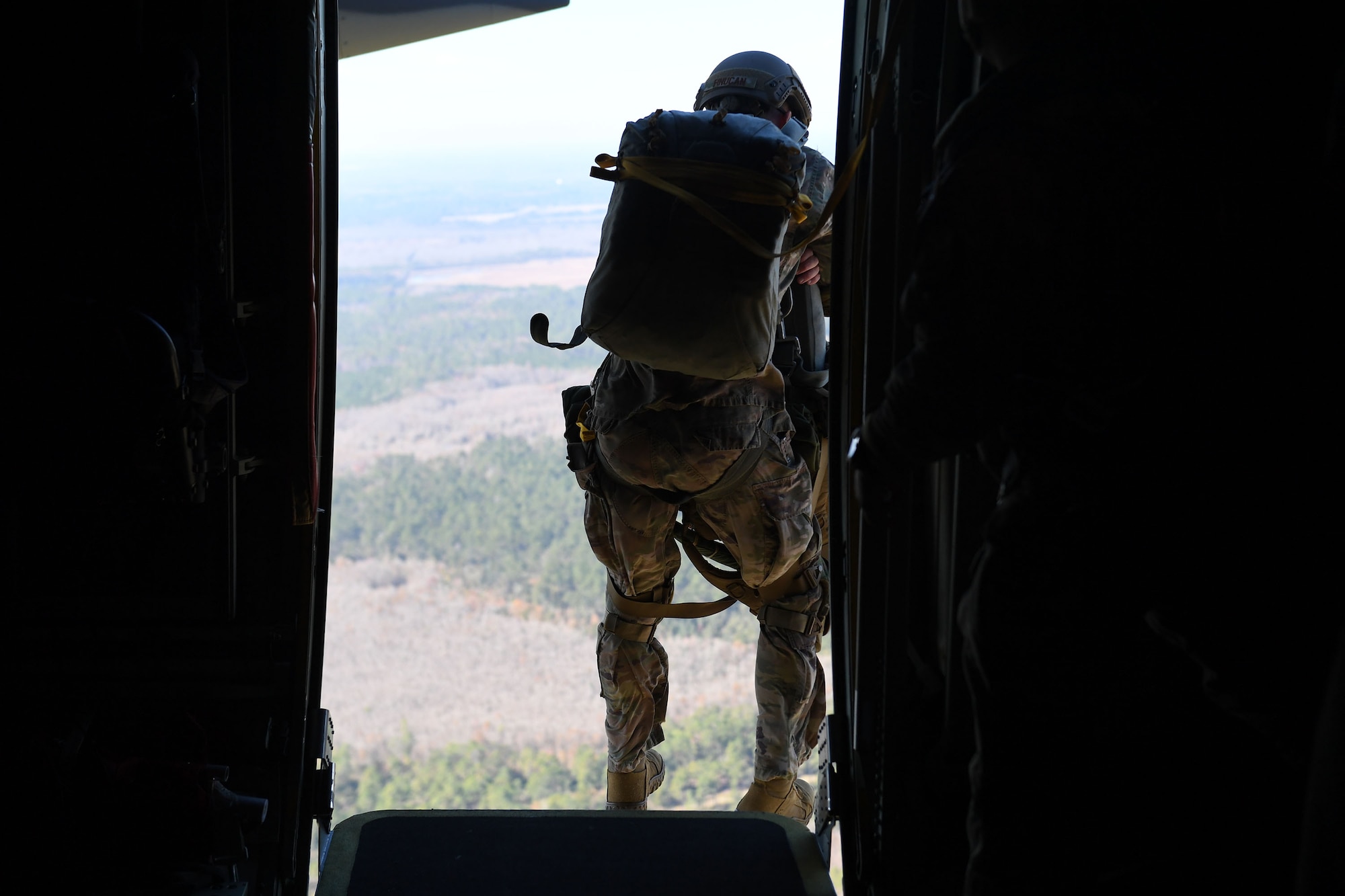 Capt. Timothy Finucan, 93d Air Ground Operations Wing jumpmaster, jumps out of an HC-130J Combat King II on a static-line parachute, Nov. 21, 2018, near Moody Air Force Base, Ga. The overall objective of the training was to increase jumpers’ skills, knowledge and proficiency in regards to airborne operations. During a static-line jump, the jumper is attached to the aircraft via the ‘static-line’, which automatically deploys the jumpers’ parachute after they’ve exited the aircraft. (U.S. Air Force photo by 1st Lt. Faith Brodkorb)