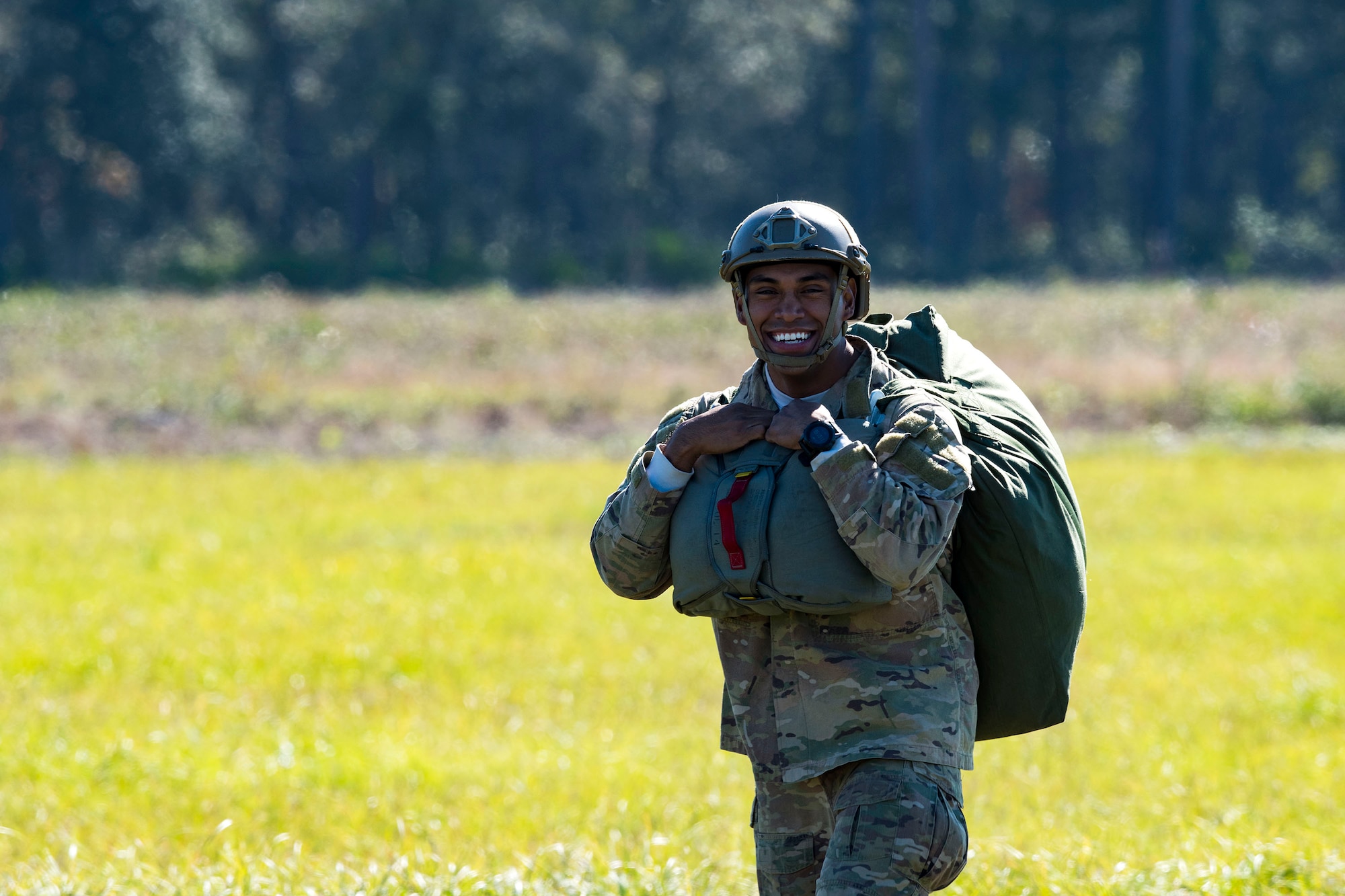 Tech. Sgt. Christopher Zavala, 822d Base Defense Squadron jumpmaster, walks away from a drop zone after packing up his parachute during static-line jump training, Nov. 21, 2018, at Moody Air Force Base, Ga. The overall objective of the training was to increase jumpers’ skills, knowledge and proficiency in regards to airborne operations. During a static-line jump, the jumper is attached to the aircraft via the ‘static-line’, which automatically deploys the jumpers’ parachute after they’ve exited the aircraft. (U.S. Air Force photo by Airman 1st Class Erick Requadt)