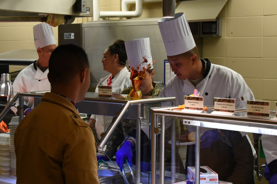 U.S. Air Force Lt. Col. Abraham Salomon, 17th Training Group deputy commander, prepares a plate for an attendee of the Thanksgiving Day lunch at the Western Winds Dining Facility on Goodfellow Air Force Base, Texas, Nov. 22, 2018. While many families spent Thanksgiving Day together, Goodfellow leadership spent their time serving students and permanent party members to say thank you. (U.S. Air Force photo by Airman 1st Class Zachary Chapman/Released)