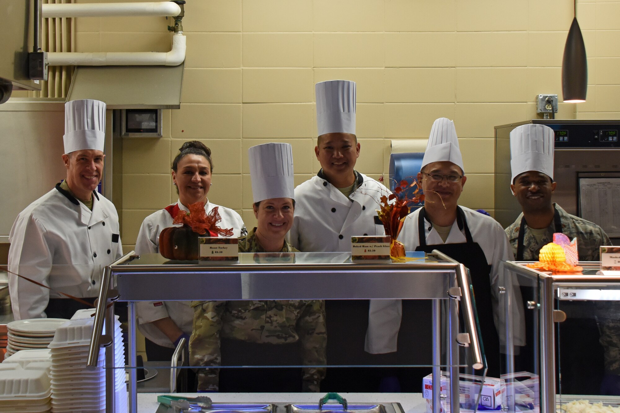 Leadership poses for a photo after the Thanksgiving Day lunch held at the Western Winds Dining Facility on Goodfellow Air Force Base, Texas, Nov. 22, 2018. The event provided a holiday experience for those unable to go home to family and friends this Thanksgiving. (U.S. Air Force photo by Airman 1st Class Zachary Chapman/Released)