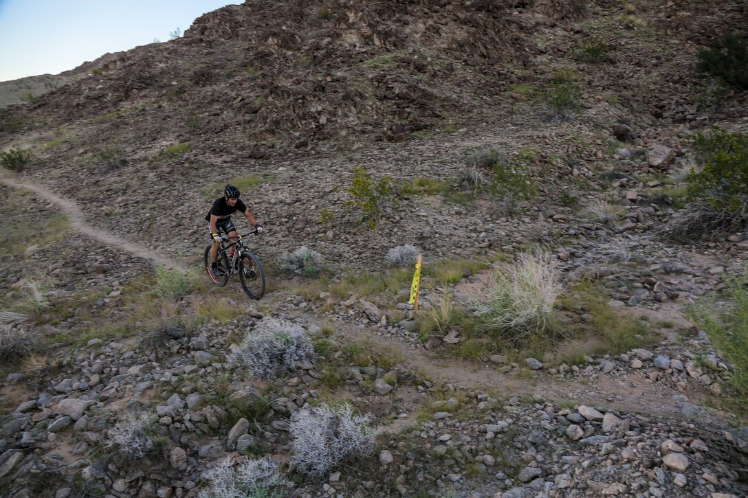 A competitor within the bike route participates in the first annual Telegraph Pass Challenge in Yuma, Ariz., Nov. 3, 2018. The challenge, coordinated by Marine Corps Community Services (MCCS), offered participants the opportunity to compete for first, second, or third place in either a 5 mile run, 5 mile bike route, or both. The course included a "Blue Mile" which is typically the most difficult portion of the racing event being a silent mile. The "Blue Mile" honors and remembers all fallen heroes of the Military, Police, and Fire Department. (U.S. Marine Corps photo by Sgt. Allison Lotz)