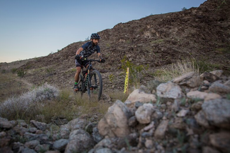 A competitor within the bike route participates in the first annual Telegraph Pass Challenge in Yuma, Ariz., Nov. 3, 2018. The challenge, coordinated by Marine Corps Community Services (MCCS), offered participants the opportunity to compete for first, second, or third place in either a 5 mile run, 5 mile bike route, or both. The course included a "Blue Mile" which is typically the most difficult portion of the racing event being a silent mile. The "Blue Mile" honors and remembers all fallen heroes of the Military, Police, and Fire Department. (U.S. Marine Corps photo by Sgt. Allison Lotz)