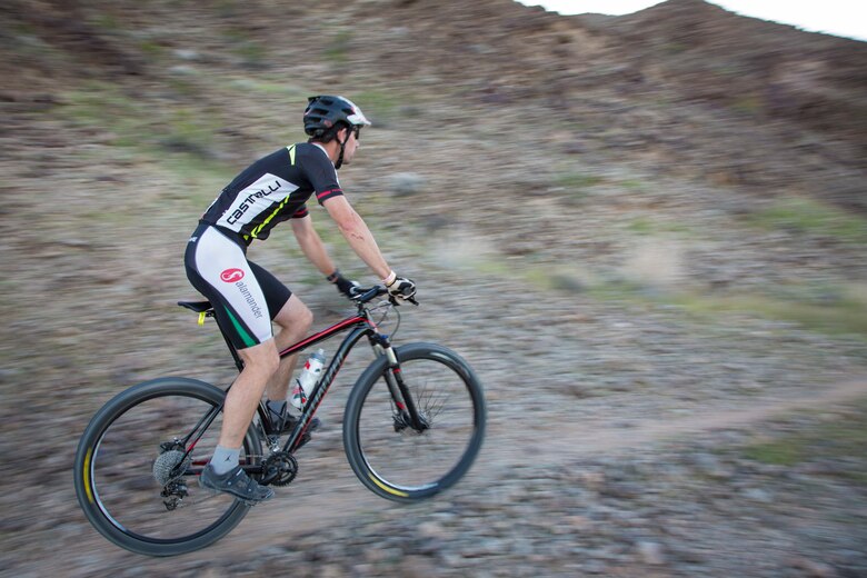 A competitor within the bike route participates in the first annual Telegraph Pass Challenge in Yuma, Ariz., Nov. 3, 2018. The challenge, coordinated by Marine Corps Community Services (MCCS), offered participants the opportunity to compete for first, second, or third place in either a 5 mile run, 5 mile bike route, or both. The course included a "Blue Mile" which is typically the most difficult portion of the racing event being a silent mile. The "Blue Mile" honors and remembers all fallen heroes of the Military, Police, and Fire Department. (U.S. Marine Corps photo by Sgt. Allison Lotz)